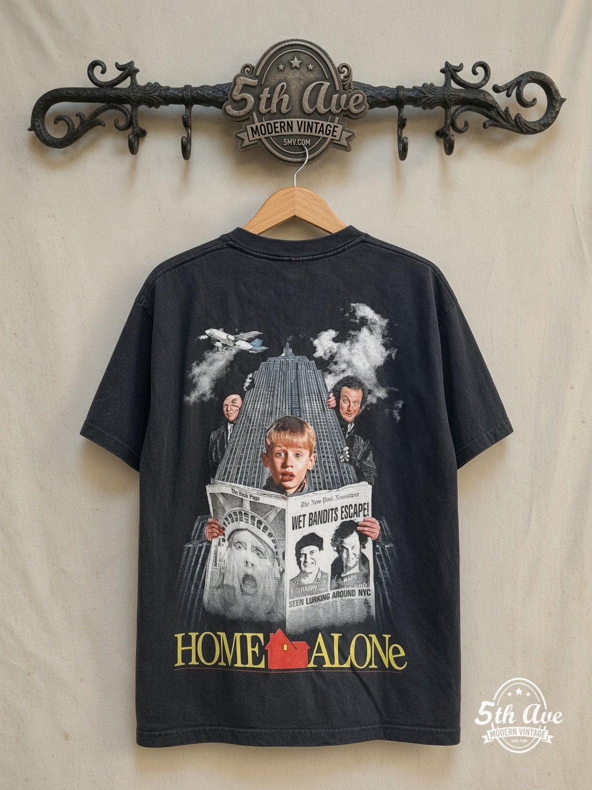 Home Alone movie tee in black, back view on a display rack