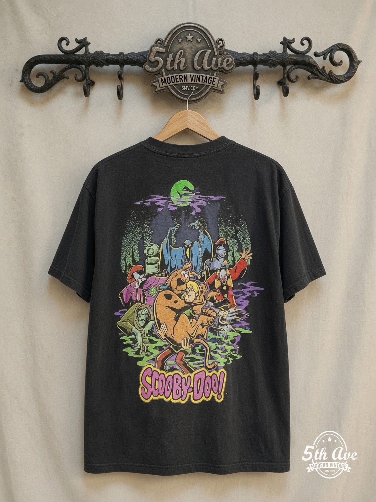 Scooby-Doo Haunted Mansion graphic tee in black, back view on a display rack