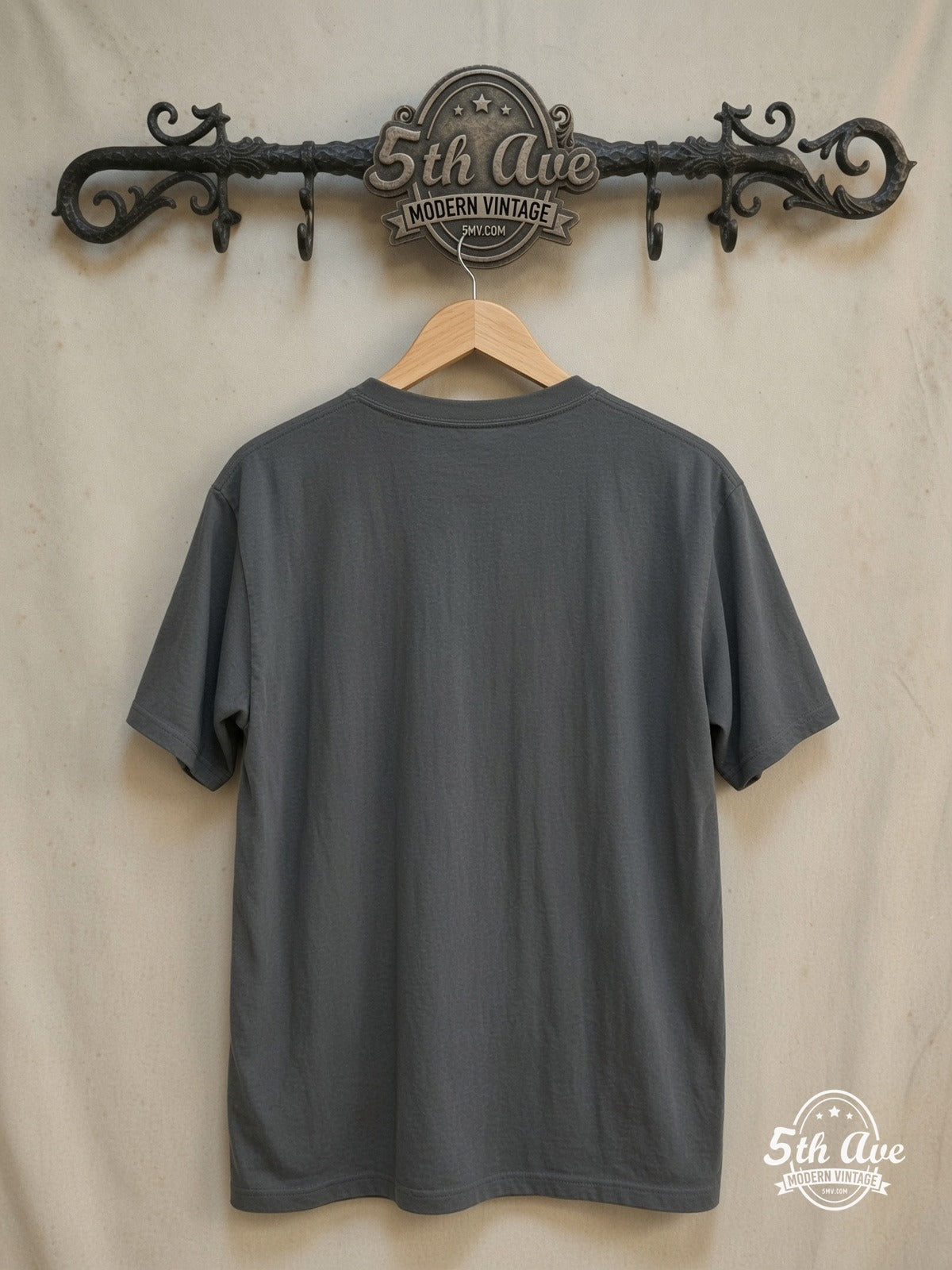 Nirvana – Vintage-Inspired Streetwear T-Shirt: Single Stitch, Light Blue Screen  – Vintage Band T-Shirt — back on locked cream ornate 5th Ave rack