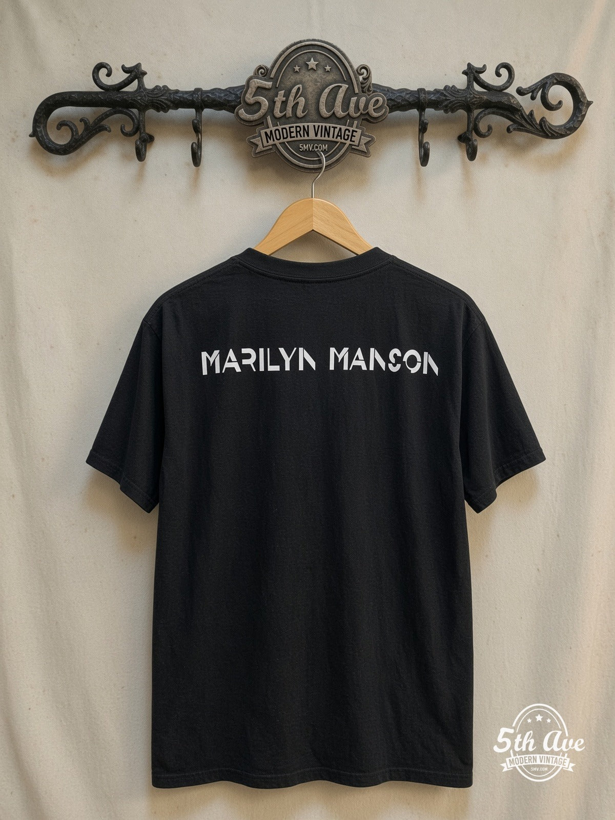 Marilyn Manson – Retro Vintage Iconic Band Design T-Shirt – Vintage Band T-Shirt — back on locked cream ornate 5th Ave rack