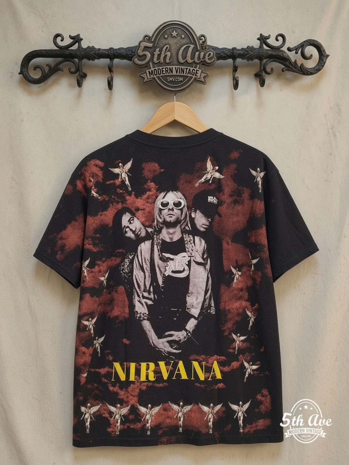 Nirvana – Nirvana Vintage Soft Cotton Band T-Shirt – All Over Print – Vintage Band T-Shirt — back on locked cream ornate 5th Ave rack
