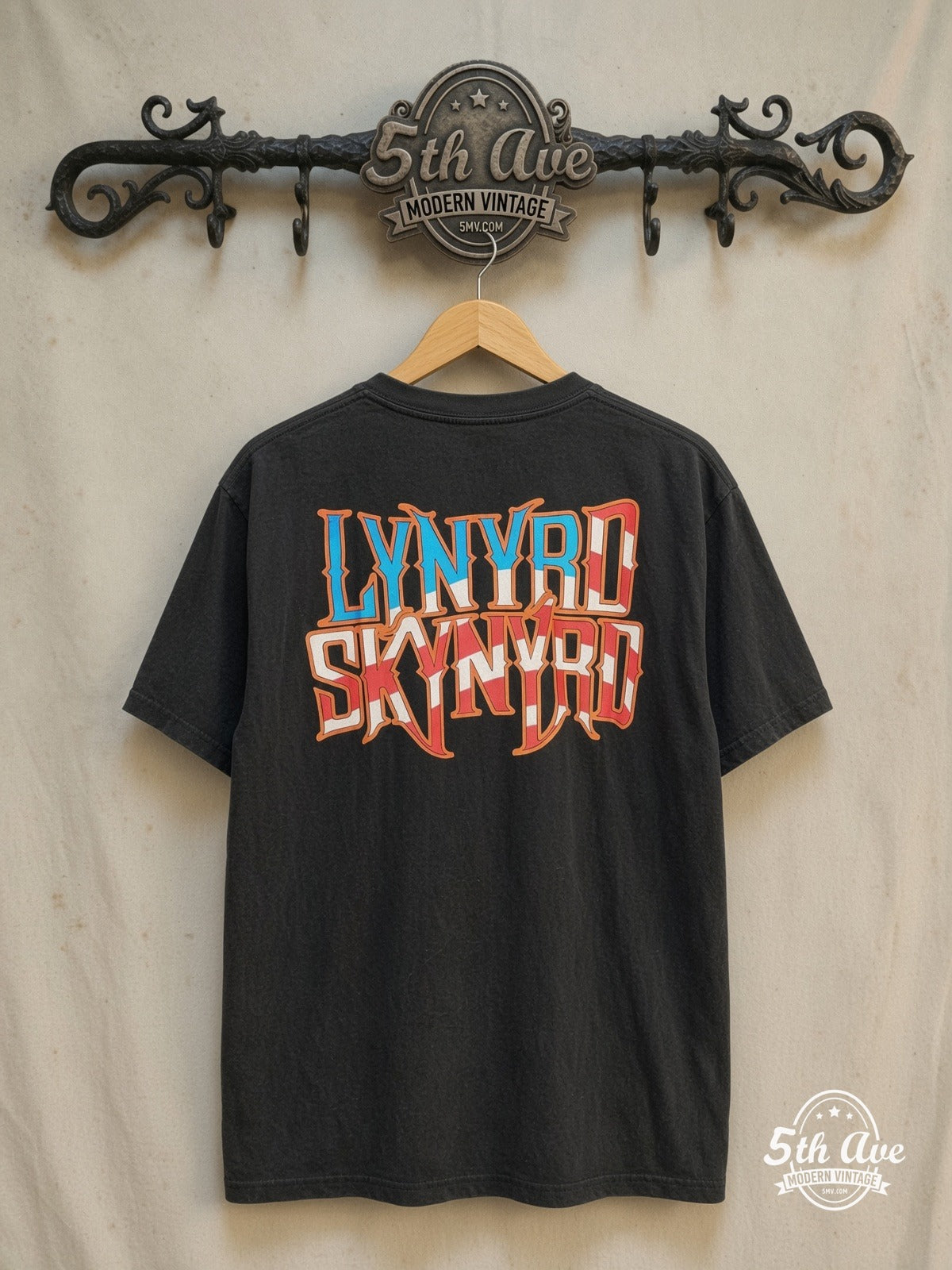 Lynyrd Skynyrd – Vintage Band T-Shirt — back on locked cream ornate 5th Ave rack