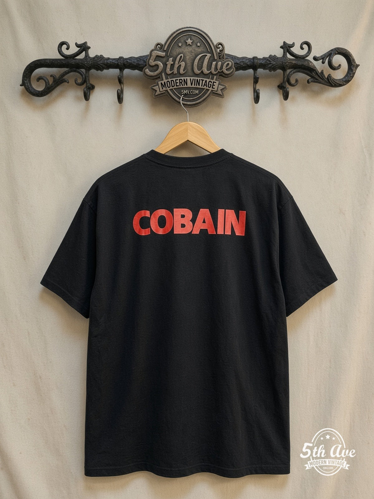 Nirvana – Classic Retro Graphic – Vintage Band T-Shirt — back on locked cream ornate 5th Ave rack