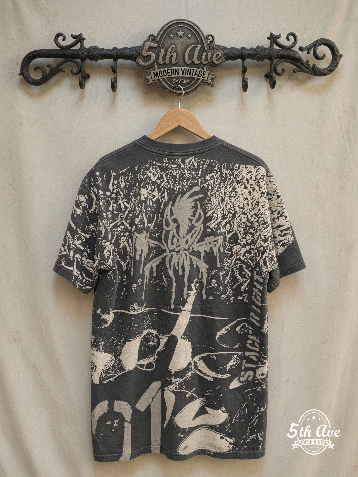 Metallica – Stage Right – All Over Print – Vintage Band T-Shirt — back on locked cream ornate 5th Ave rack
