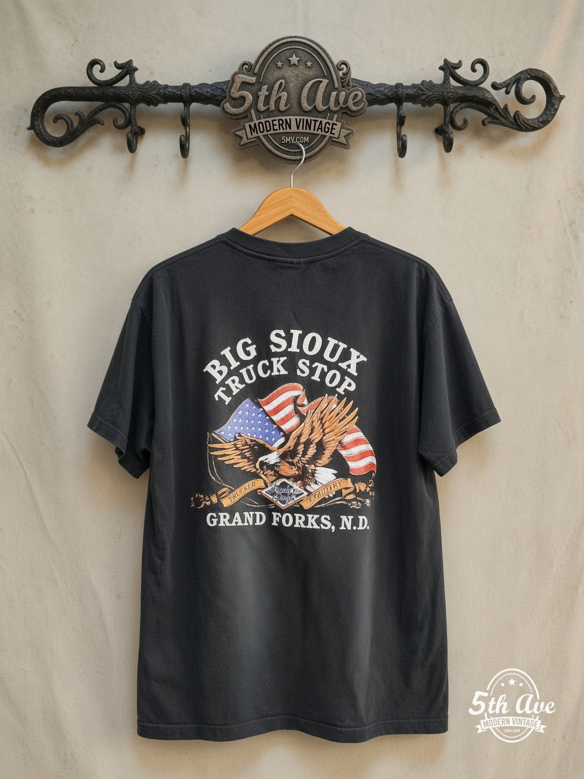 Road Wrangler Truckers Only Big Sioux Truck Stop graphic tee in black, back view on a display rack