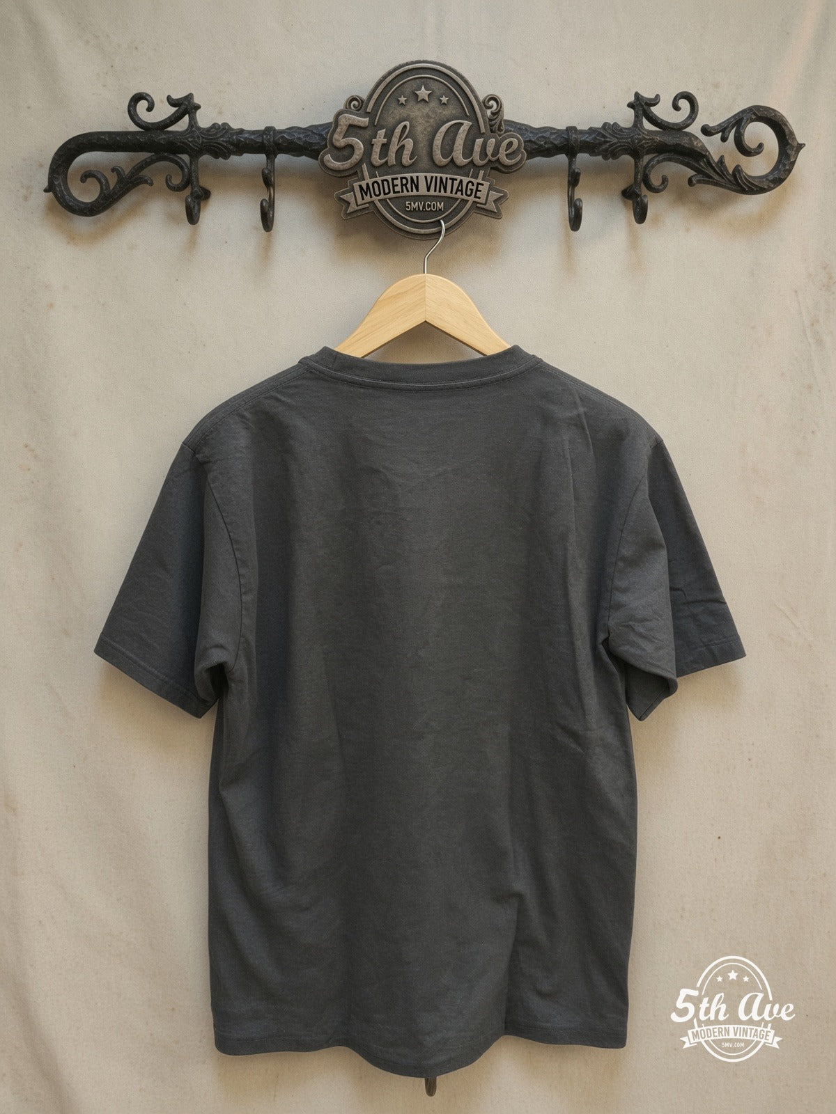 Led Zeppelin – 1973 Tour Angel & Zeppelin Black – Vintage Band T-Shirt — back on locked cream ornate 5th Ave rack