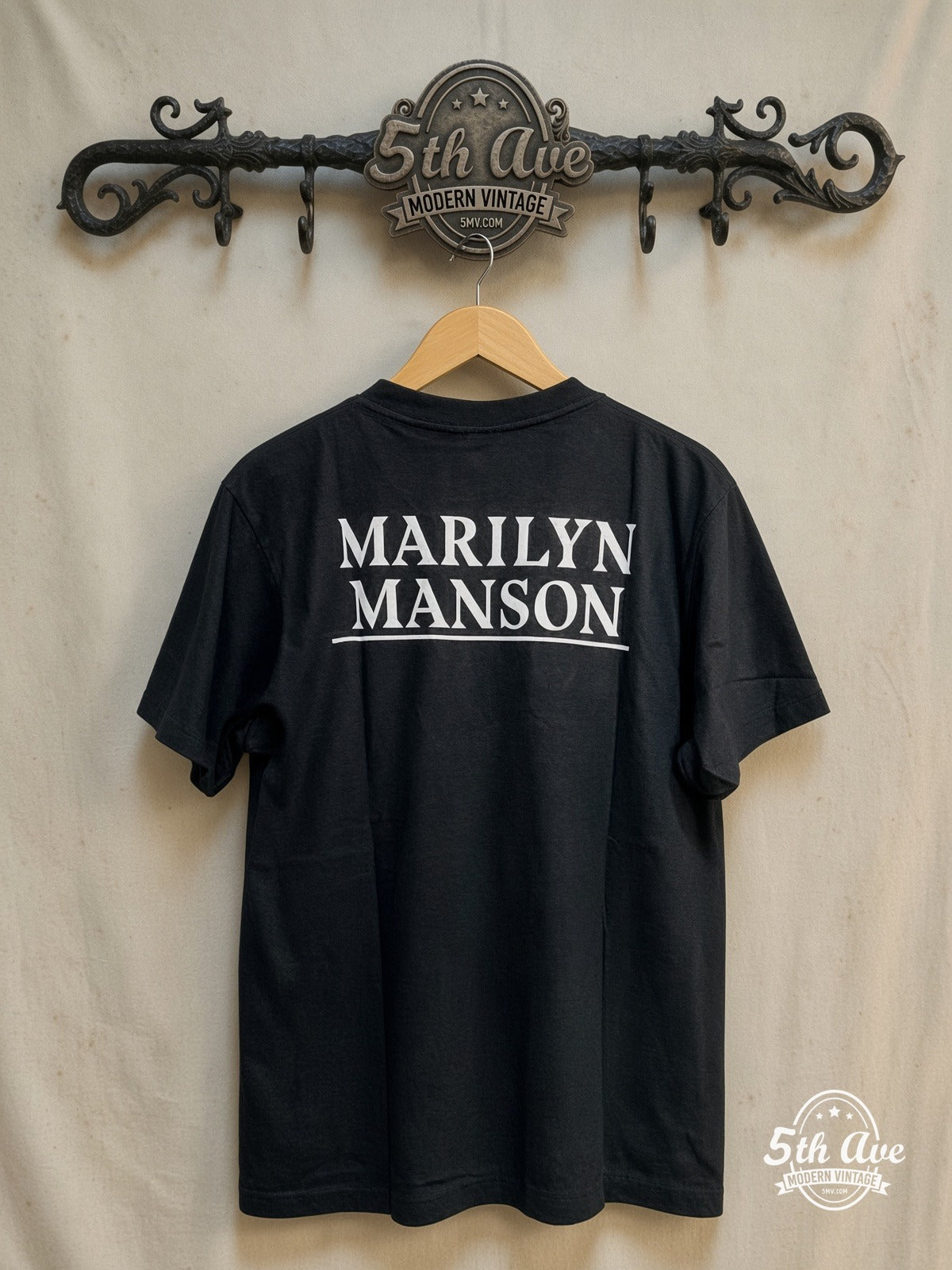 Marilyn Manson – Retro Vintage Classic Band T-Shirt – Vintage Band T-Shirt — back on locked cream ornate 5th Ave rack