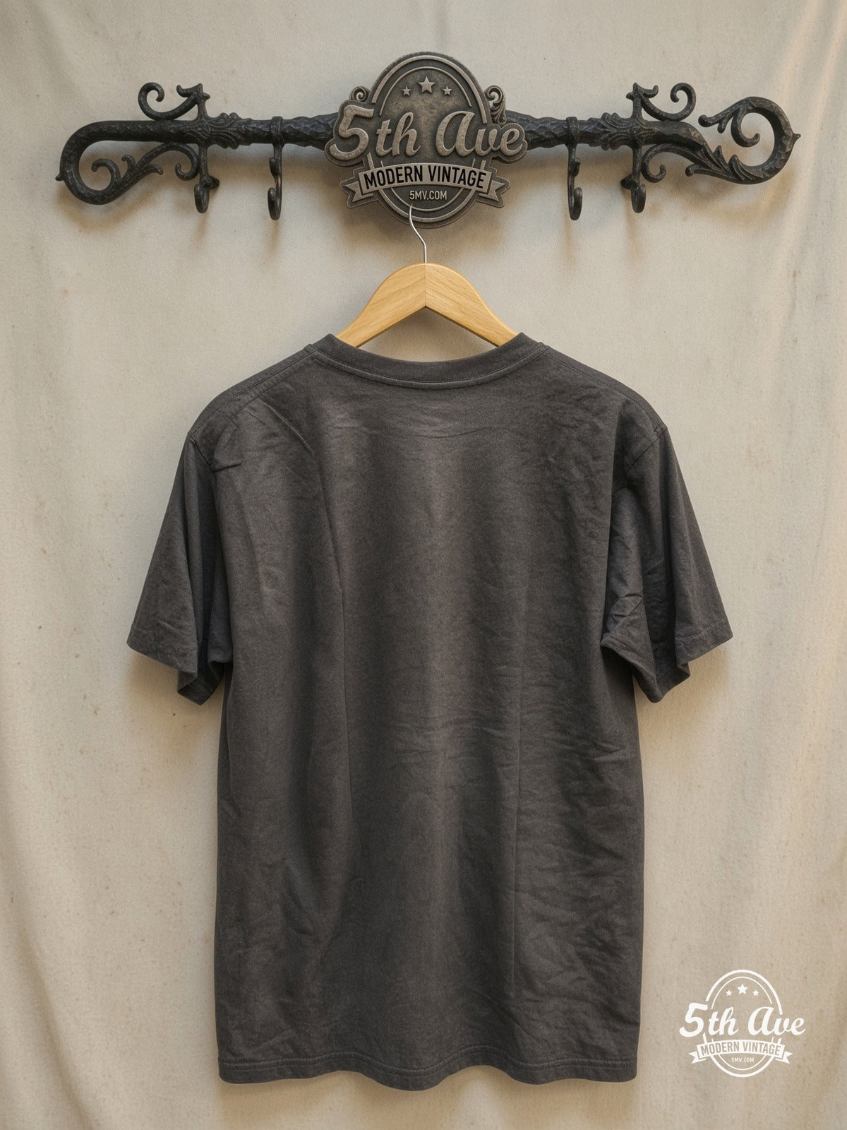 Graphic – Harmonies of History – Vintage Band T-Shirt — back on locked cream ornate 5th Ave rack