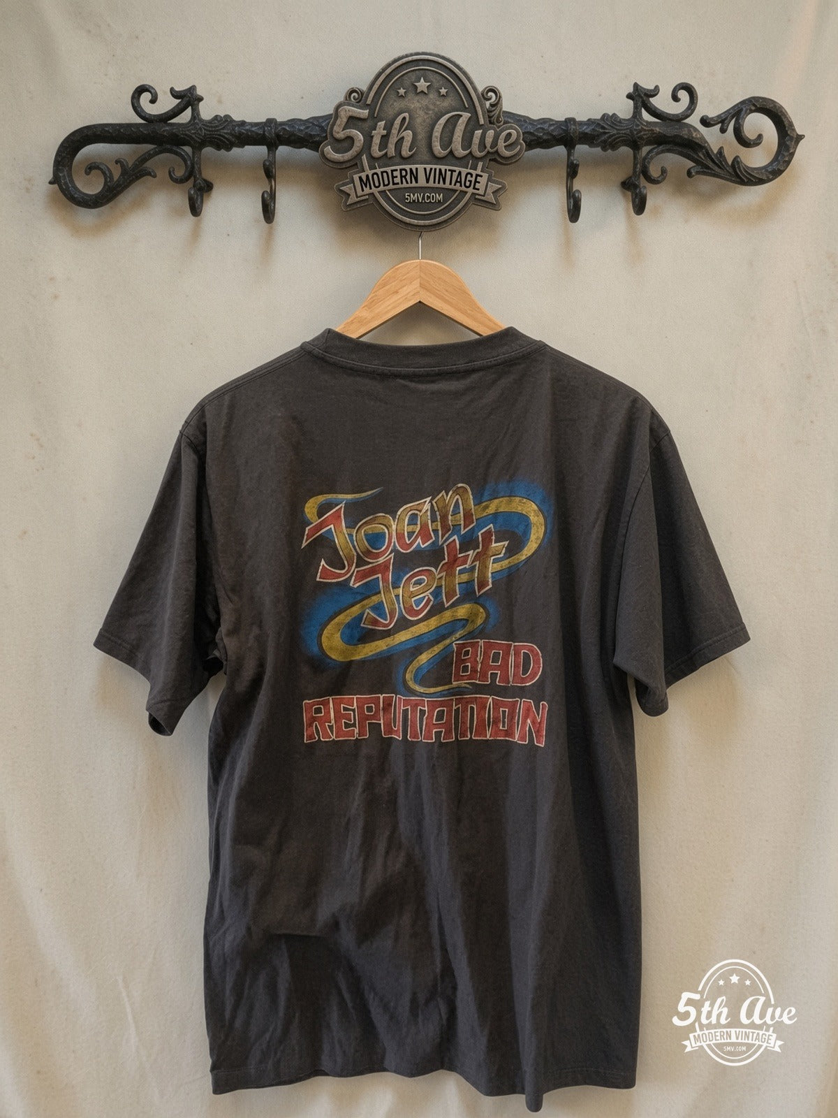 Rock Rebellion Revived: Unveiling the Joan Jett 'Bad Reputation' Vinta – ge Band Tee – Vintage Band T-Shirt — back on locked cream ornate 5th Ave rack
