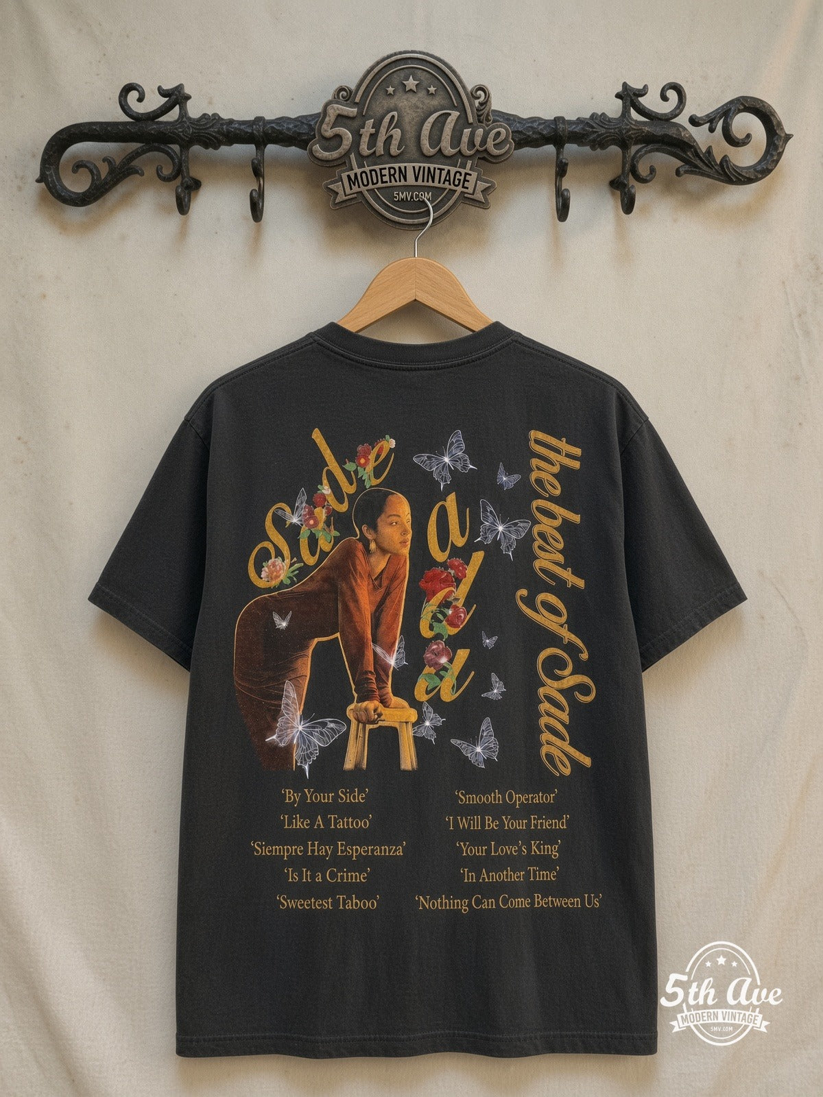 Sade – The Best of Sade – Vintage Band T-Shirt — back on locked cream ornate 5th Ave rack