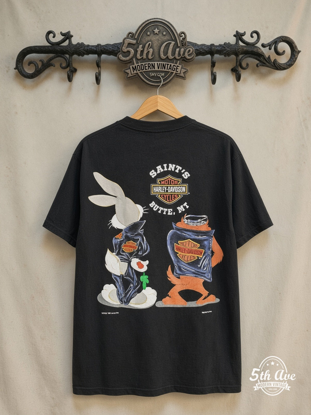 Harley-Davidson – Bugs Bunny & Taz Saints Butte MT – New Vintage Graphic Tee — back on locked cream ornate 5th Ave rack