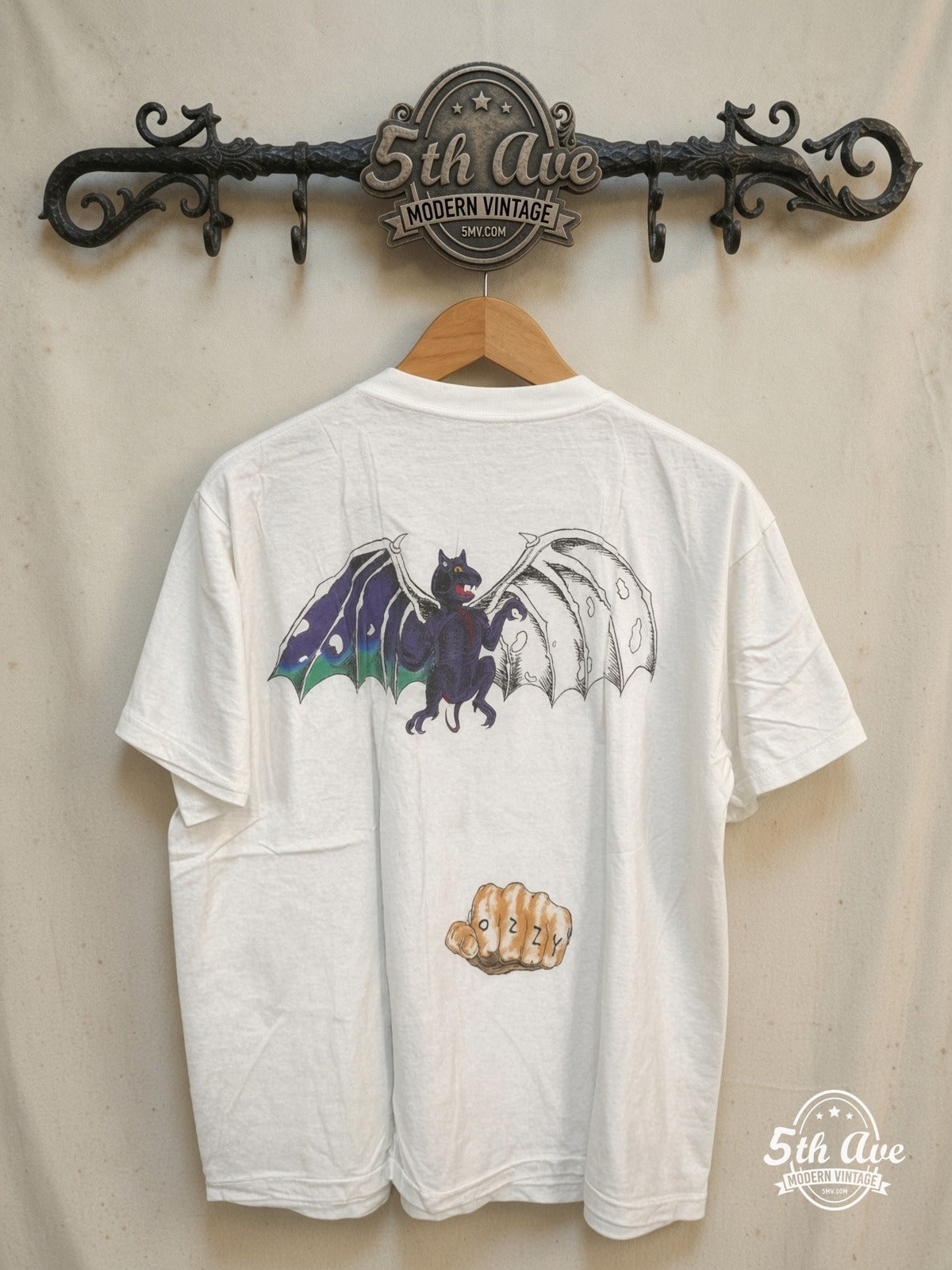Ozzy Osbourne – Ozzy's Tattoos – Vintage Band T-Shirt — back on locked cream ornate 5th Ave rack