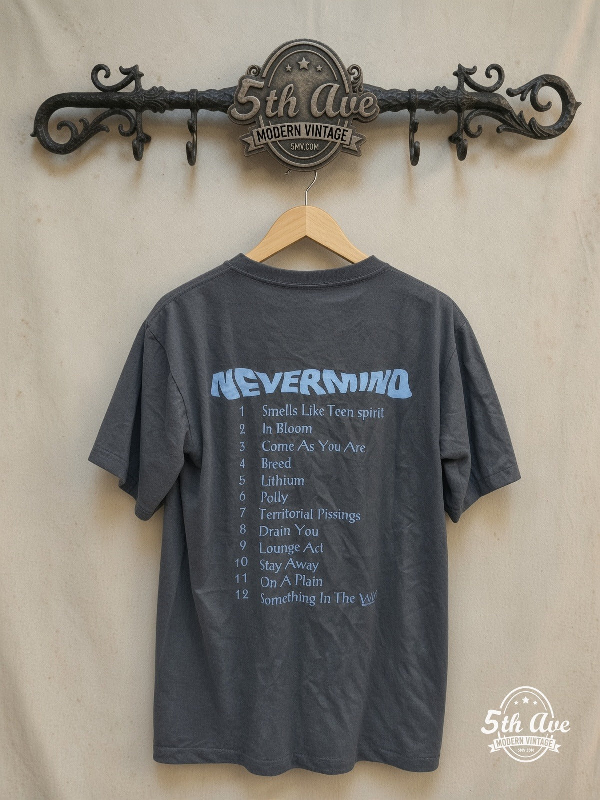 Nirvana – Nevermind Baby Cover – Vintage Band T-Shirt — back on locked cream ornate 5th Ave rack