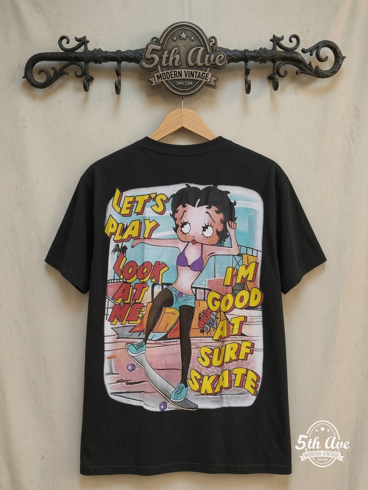 Betty Boop – I'm Good at Surf Skate - AOP all over print New Vintage Animation T-Sh – New Vintage Graphic Tee — back on locked cream ornate 5th Ave rack