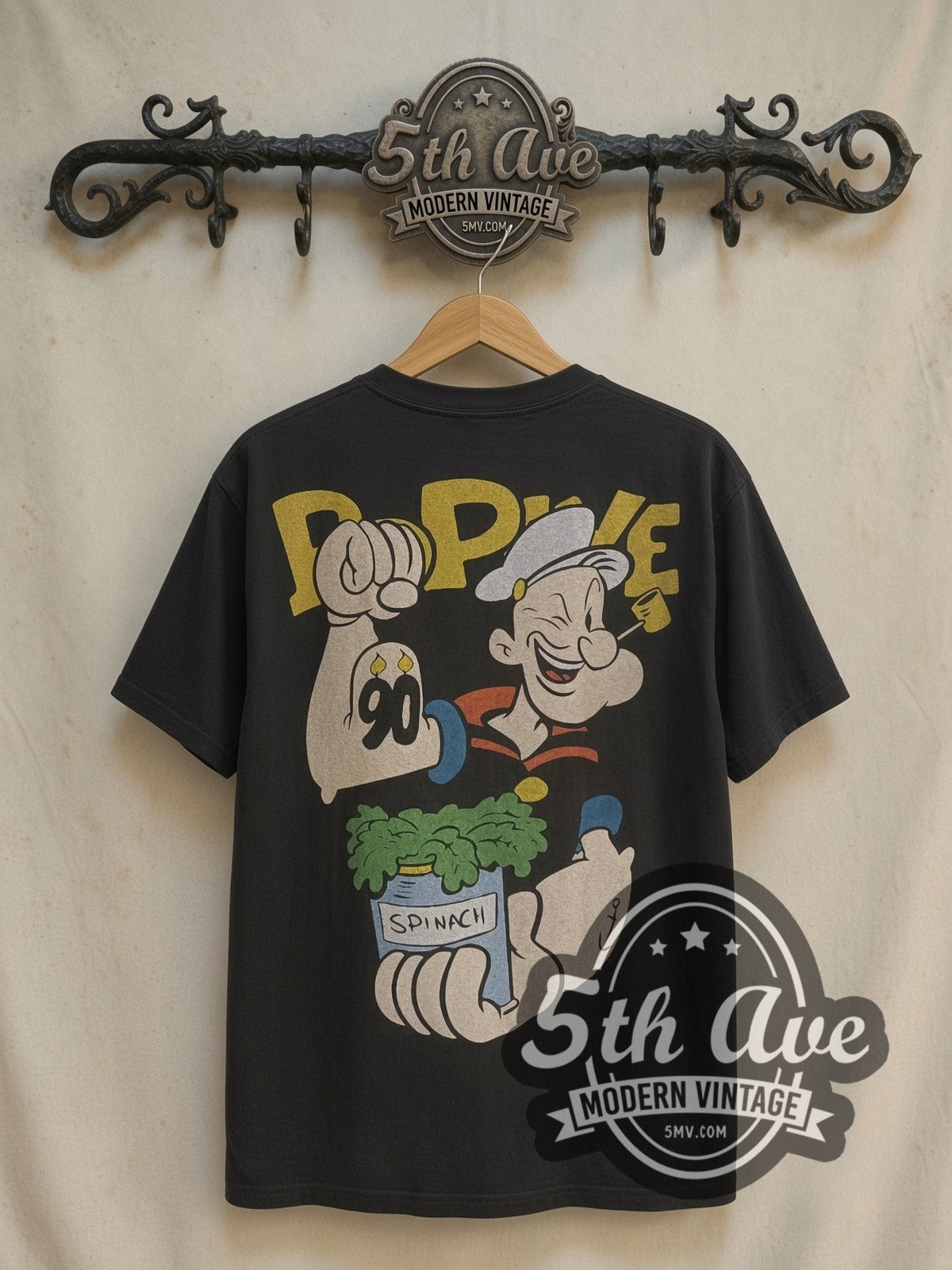 Popeye Spinach graphic tee, back view on a display rack