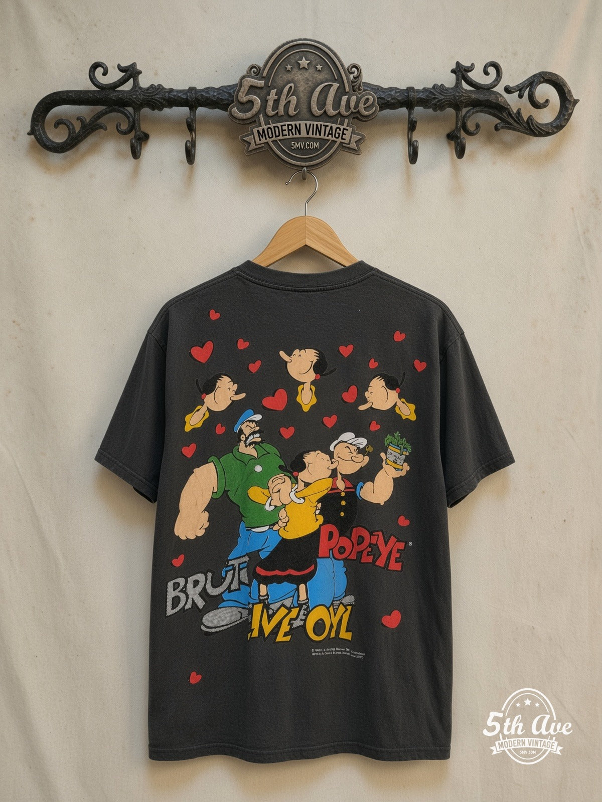 Popeye the Sailor Man – All Over Print – New Vintage Graphic Tee — back on locked cream ornate 5th Ave rack