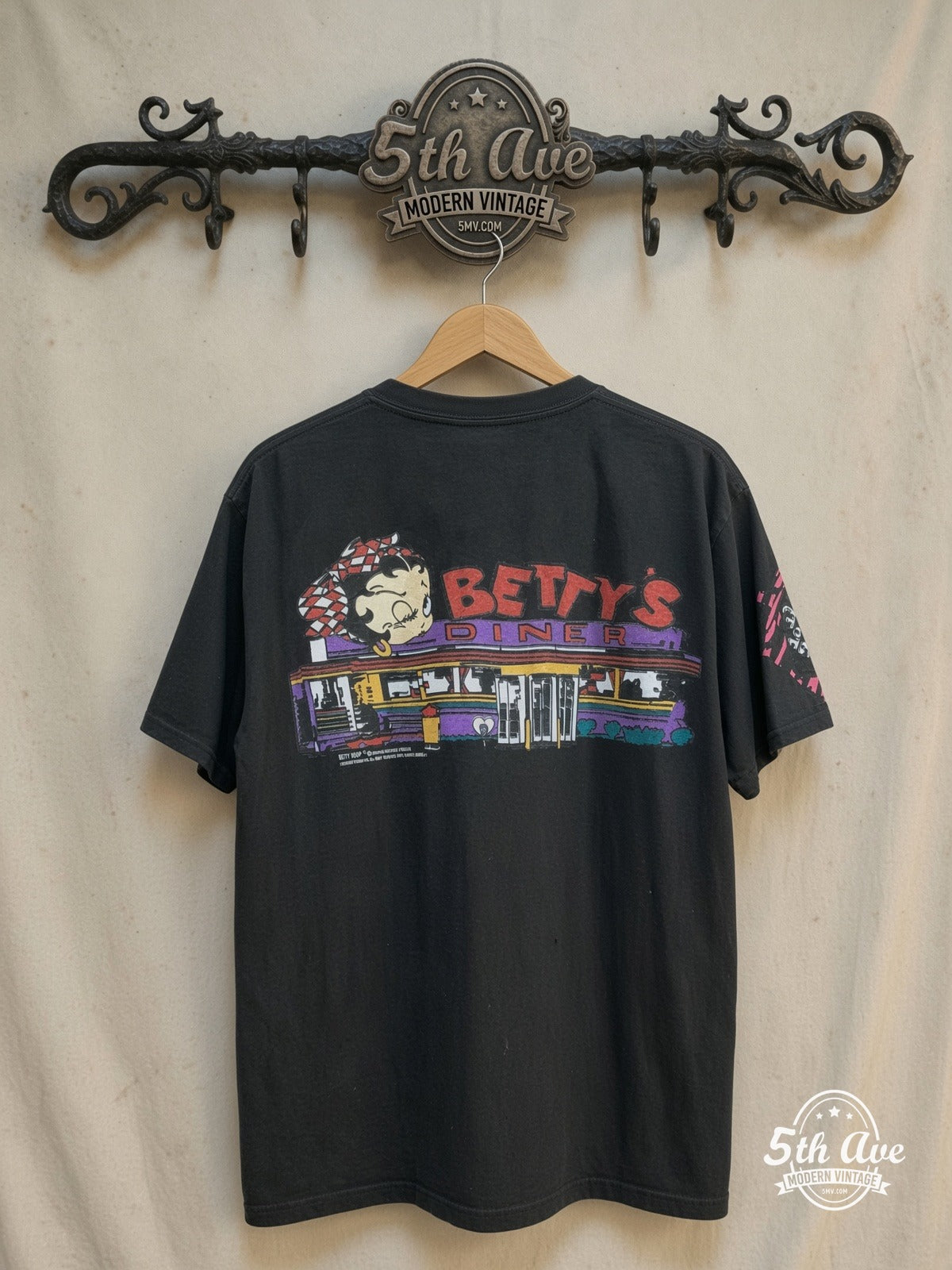 Betty Boop – Betty Boop's Diner Served Hot and Fresh – All Over Print – New Vintage Graphic Tee — back on locked cream ornate 5th Ave rack
