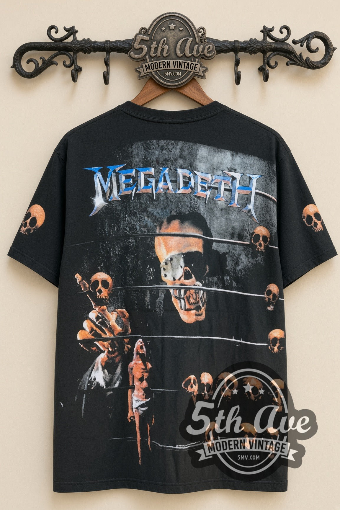 Megadeth – Vic Rattlehead Multi Skull All Over Print – Vintage Band T-Shirt, front view on a display rack
