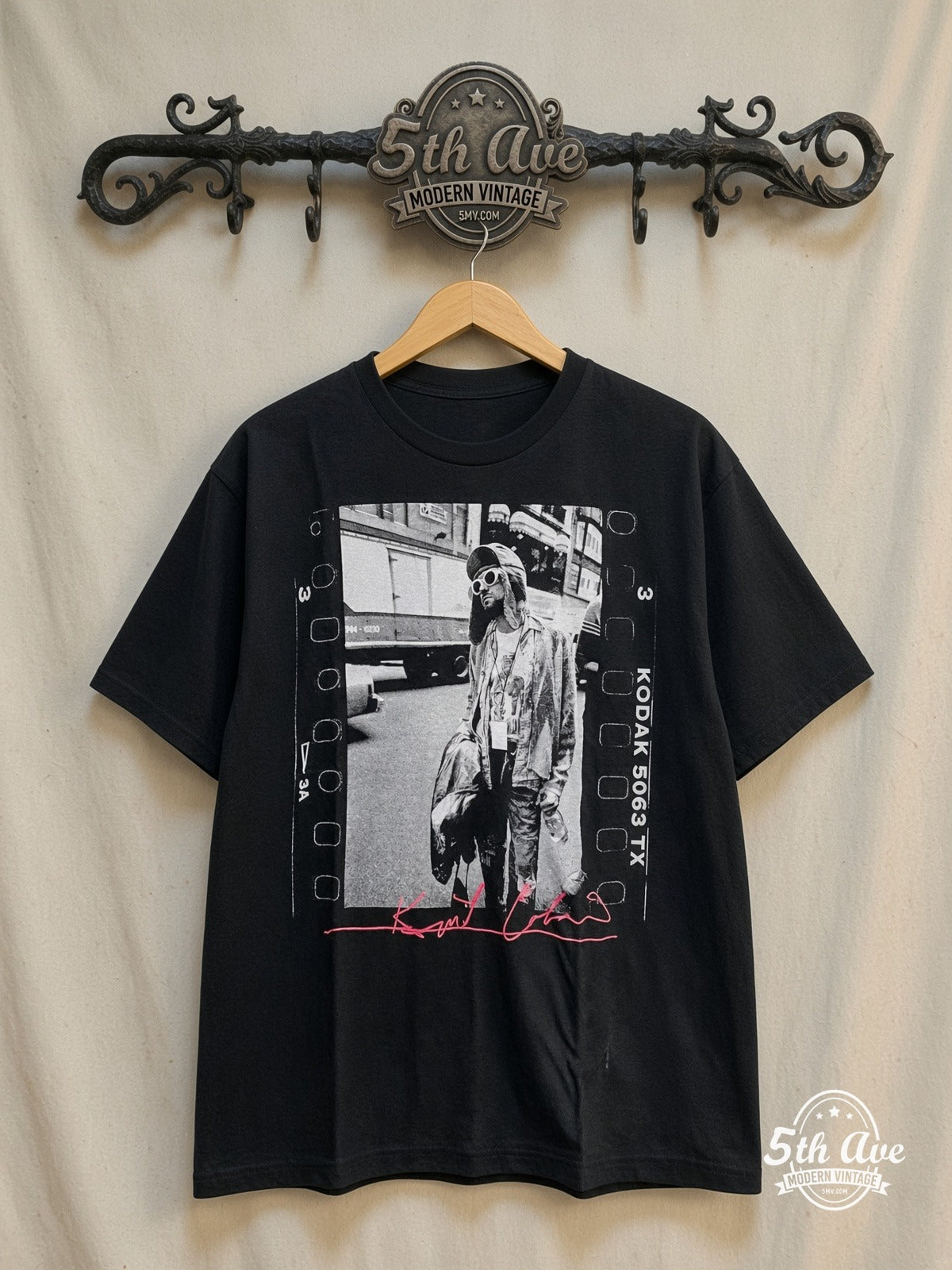Nirvana – Kurt Cobain Film Strip Pink Signature – Vintage Band T-Shirt — front on locked cream ornate 5th Ave rack