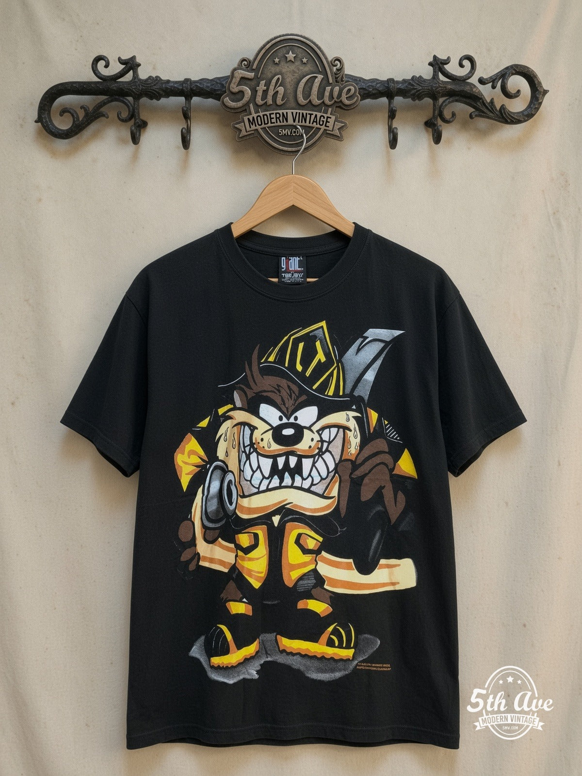 Looney Tunes Taz-Mania Fire Department all-over-print graphic tee, front view on a display rack