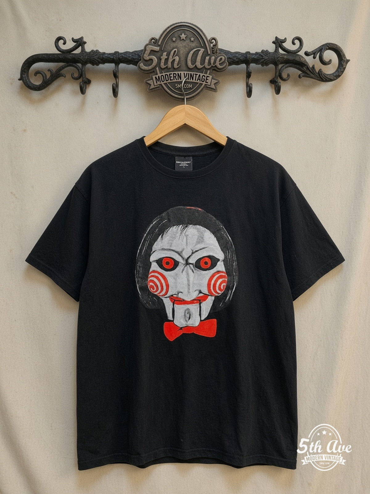 Saw – Jigsaw – Vintage Movie Tee — front on locked cream ornate 5th Ave rack