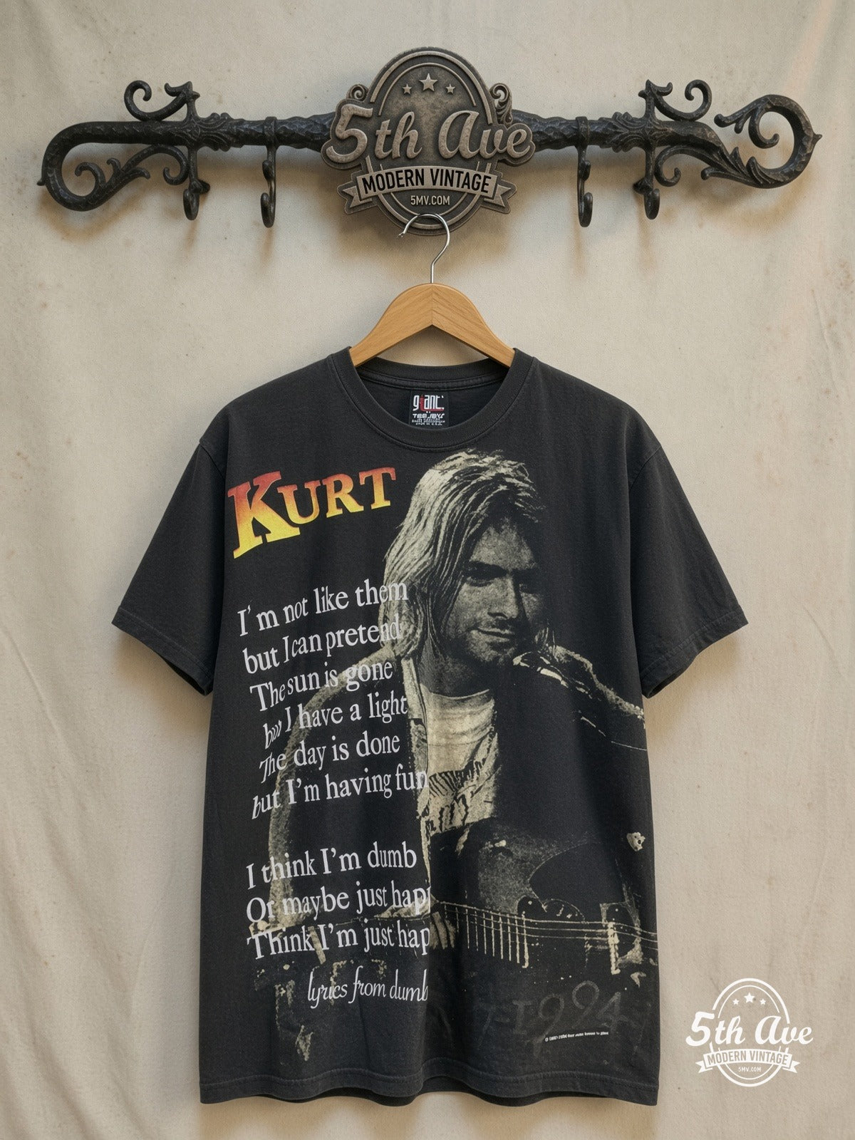 Kurt Cobain – Nirvana Live at Last – All Over Print – Vintage Band T-Shirt — front on locked cream ornate 5th Ave rack