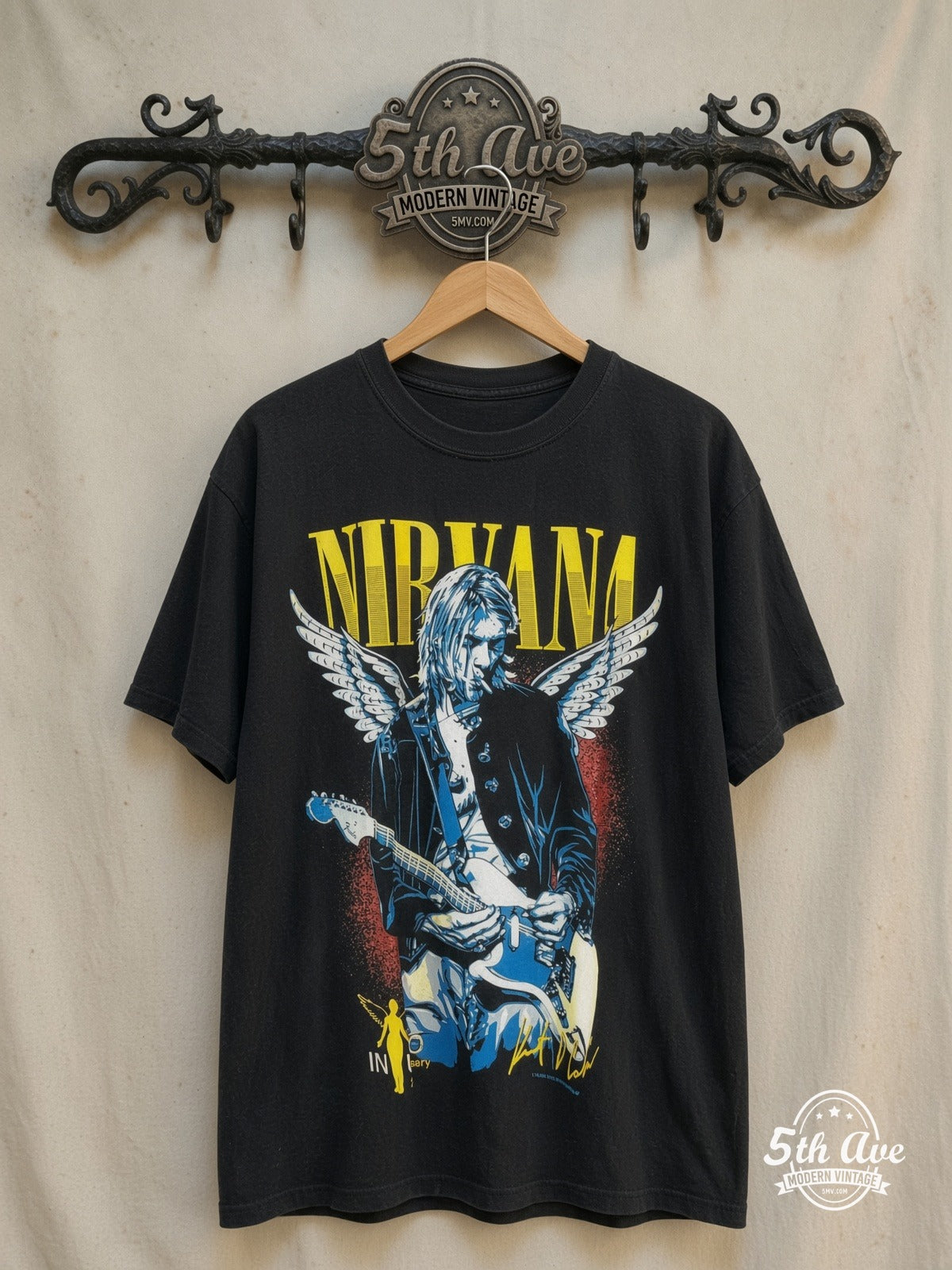 Kurt Cobain / Nirvana – Vintage Band T-Shirt — front on locked cream ornate 5th Ave rack