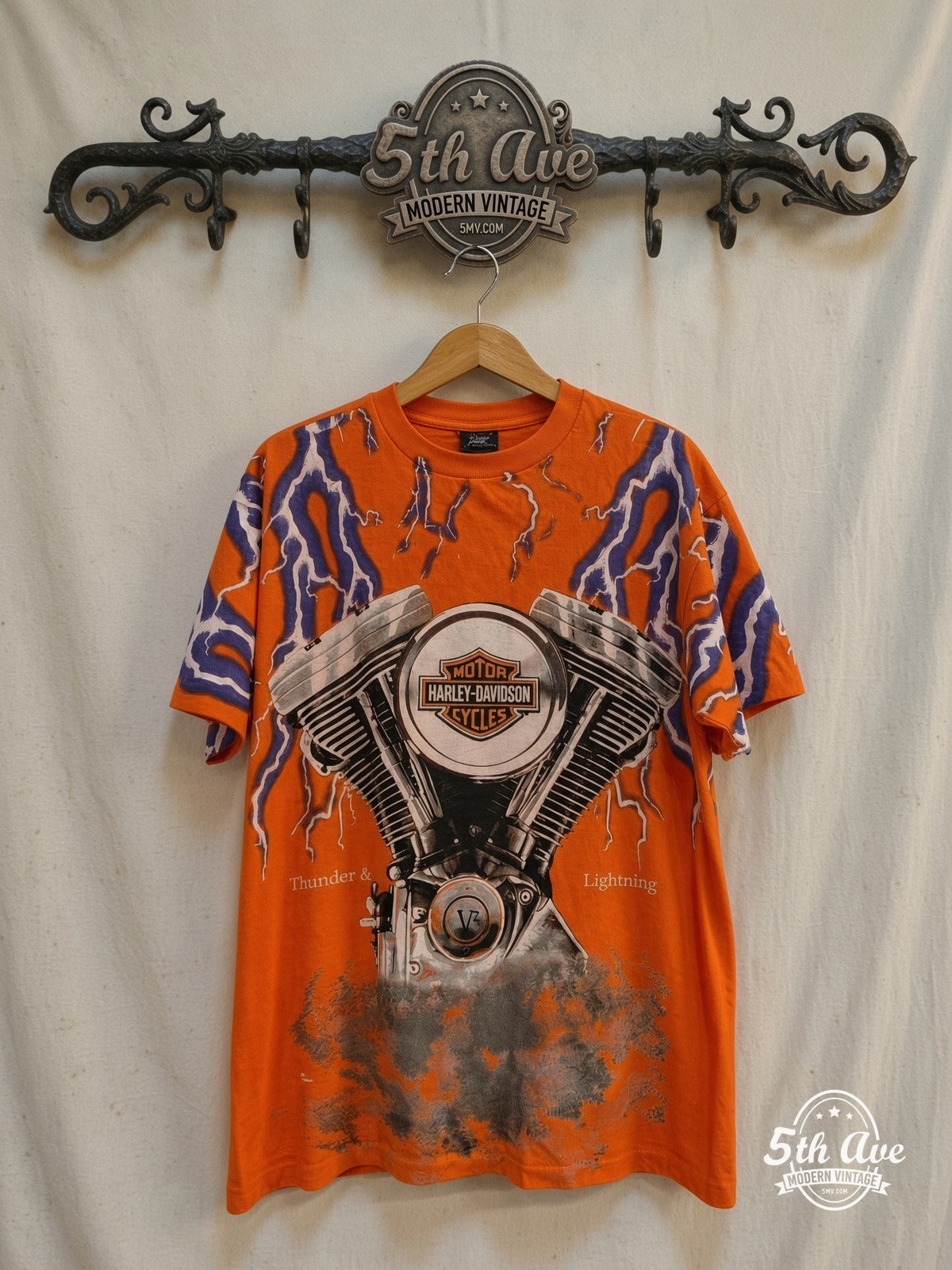 Harley-Davidson – Thunder & Lightning Appleton Wisc Orange – Vintage Band T-Shirt — front on locked cream ornate 5th Ave rack