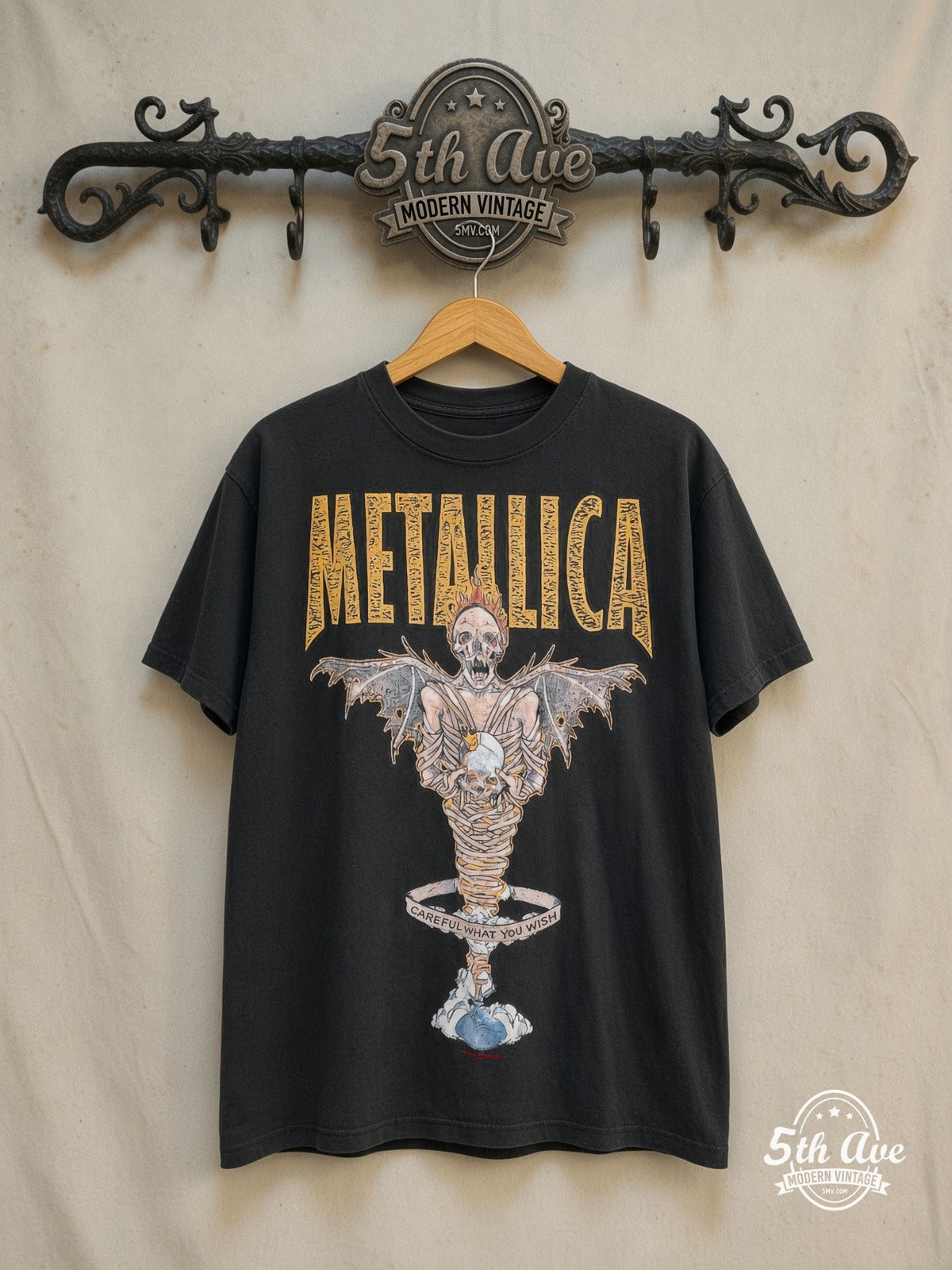 Metallica – King Nothing Careful What You Wish Winged Skeleton – Vintage Band T-Shirt — front on locked cream ornate 5th Ave rack