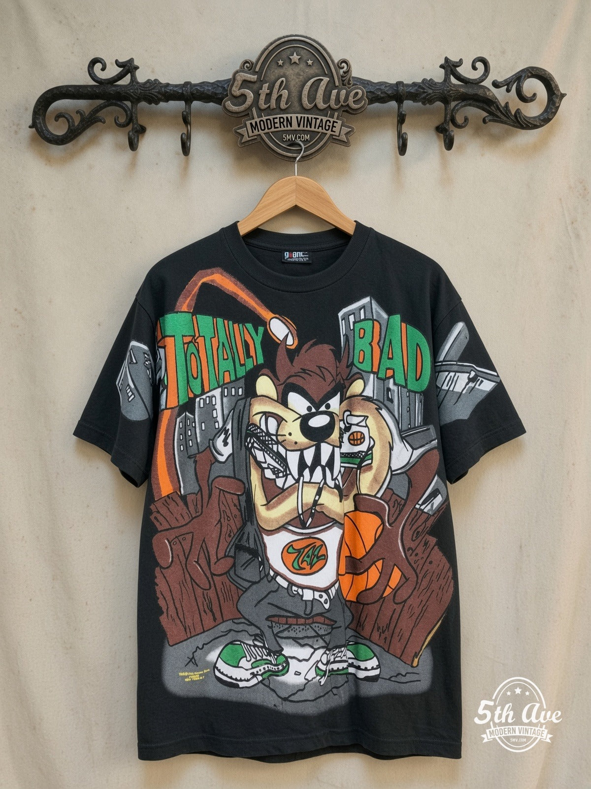 Looney Tunes – Taz-Mania Totally Bad – All Over Print – New Vintage Graphic Tee — front on locked cream ornate 5th Ave rack