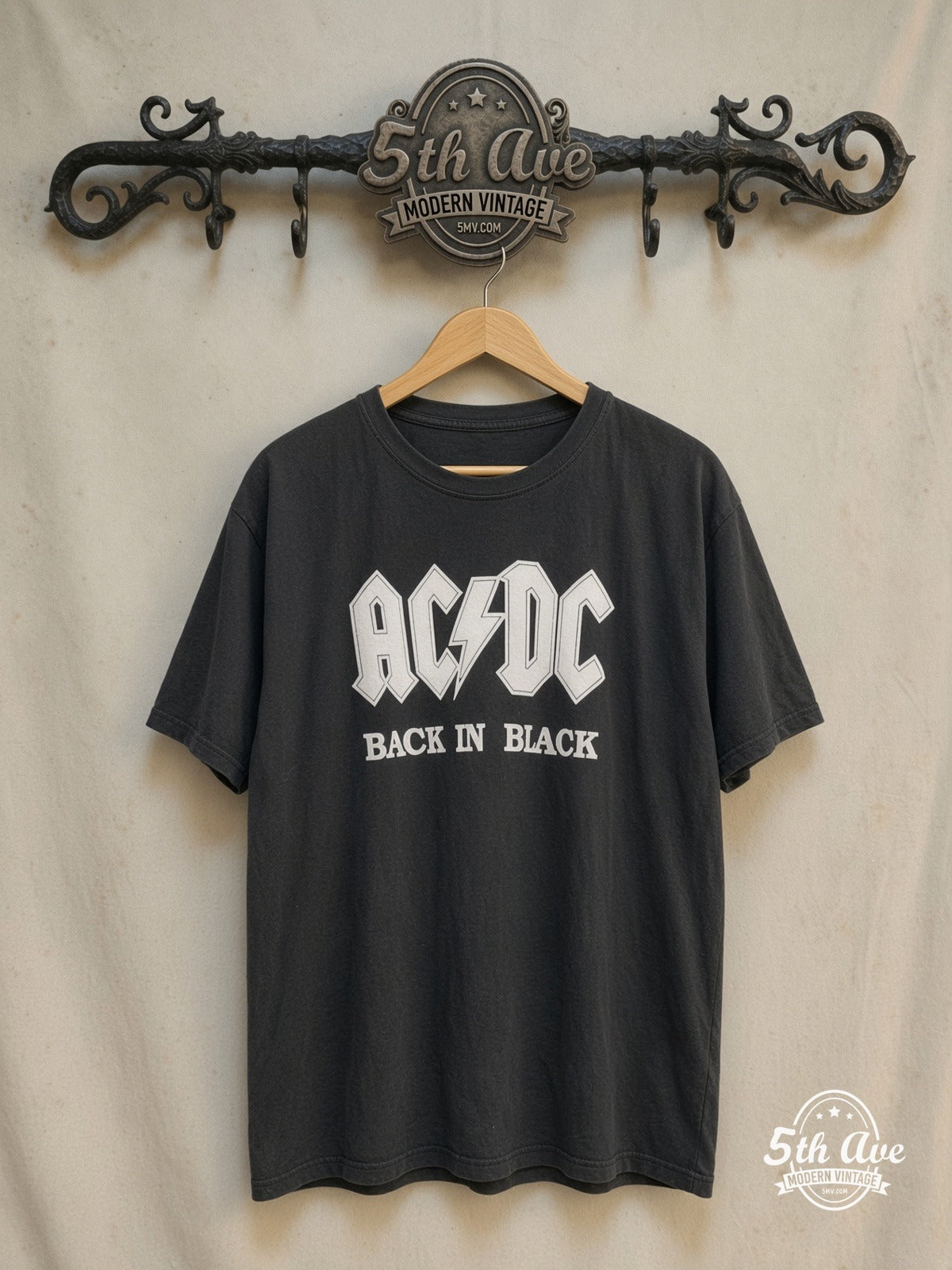 AC/DC – Classic Back In Black t shirt – Vintage Band T-Shirt — front on locked cream ornate 5th Ave rack