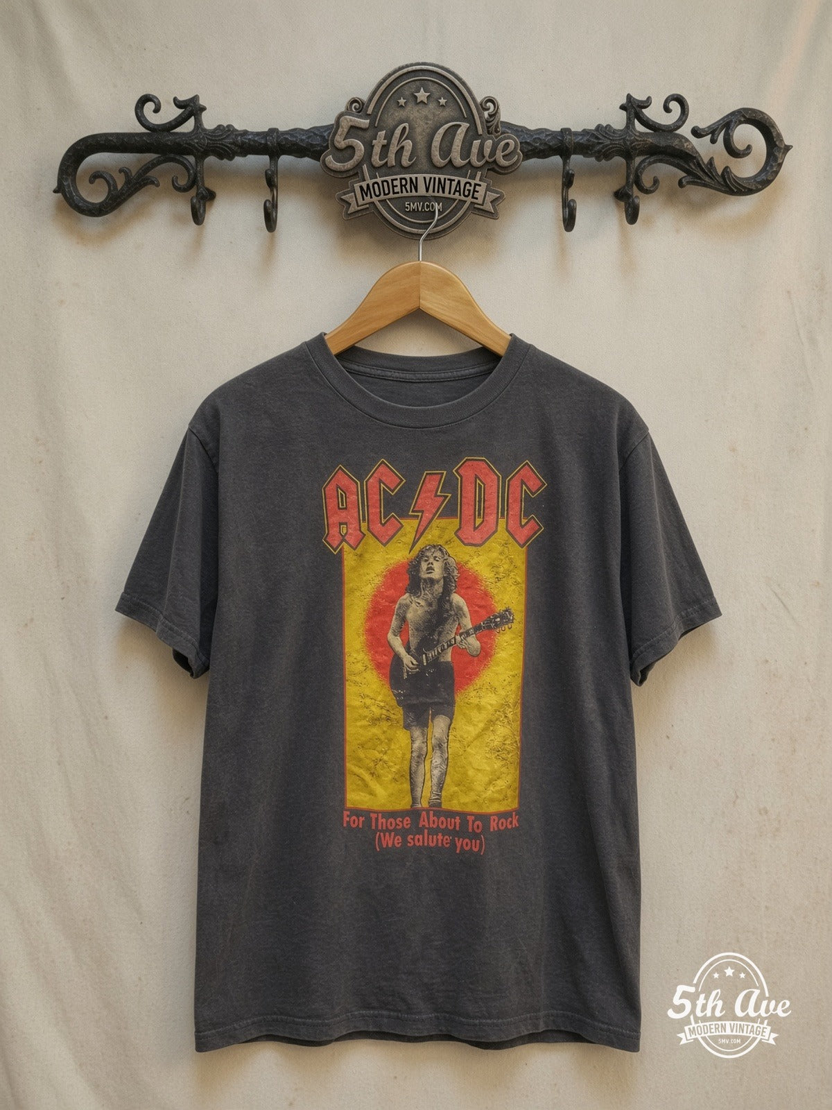AC/DC – For Those About to Rock, We Salute You" t shirt – Vintage Band T-Shirt — front on locked cream ornate 5th Ave rack