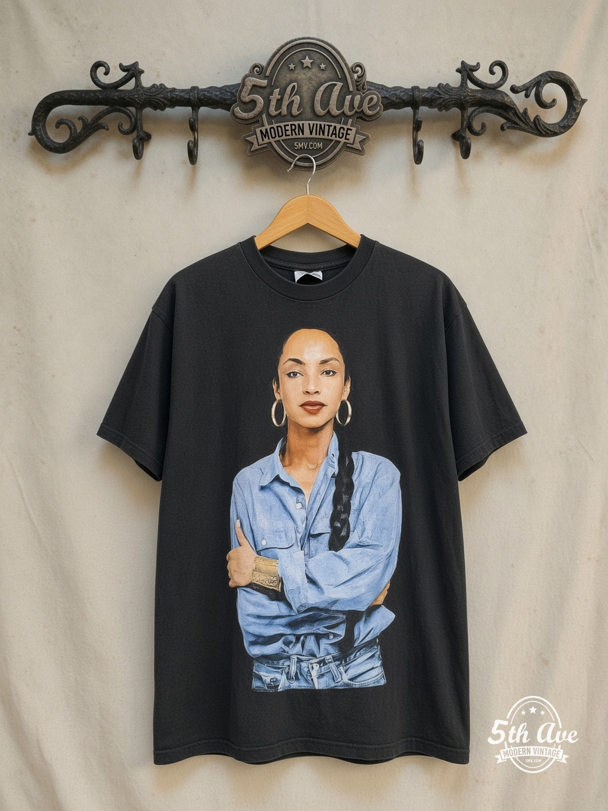 Sade – Queen of Cool Crossed Arms Denim Black – Vintage Band T-Shirt — front on locked cream ornate 5th Ave rack