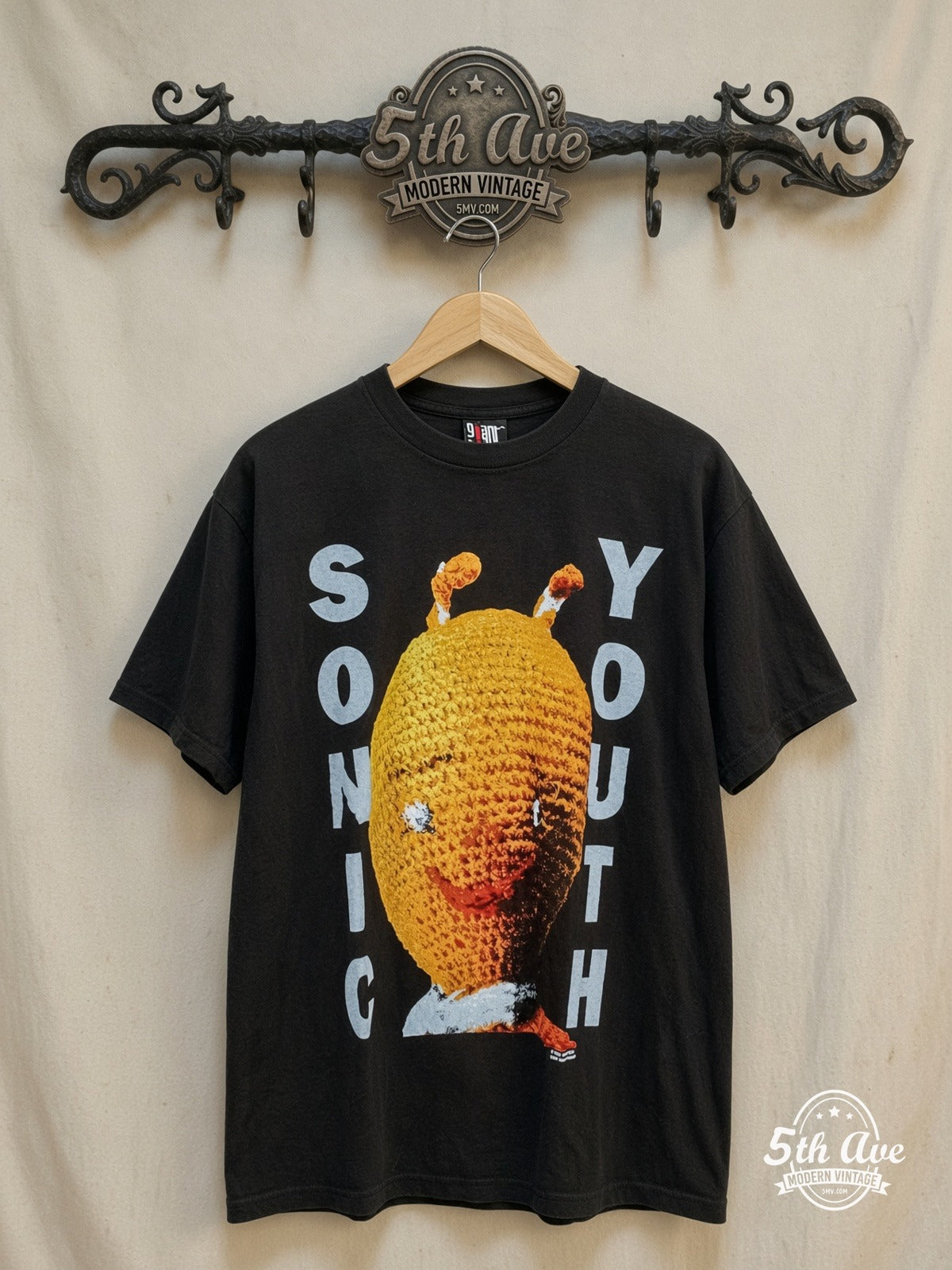 Sonic Youth – Dirty Knitted Doll – Vintage Band T-Shirt — front on locked cream ornate 5th Ave rack