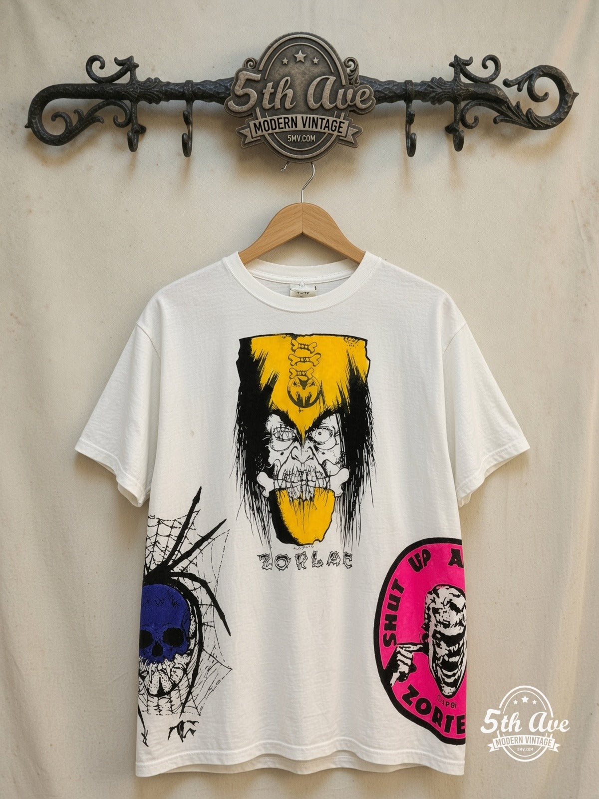 Zorlac Skateboards – Shut Up and Skate – All Over Print – Vintage Graphic Tee — front on locked cream ornate 5th Ave rack