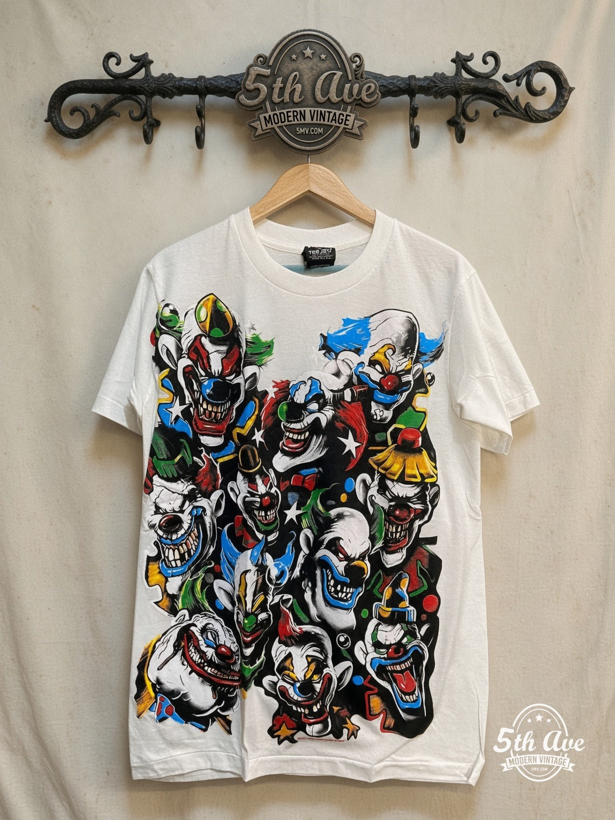 Laughing Clown – Classic Clown – Vintage Graphic Tee — front on locked cream ornate 5th Ave rack