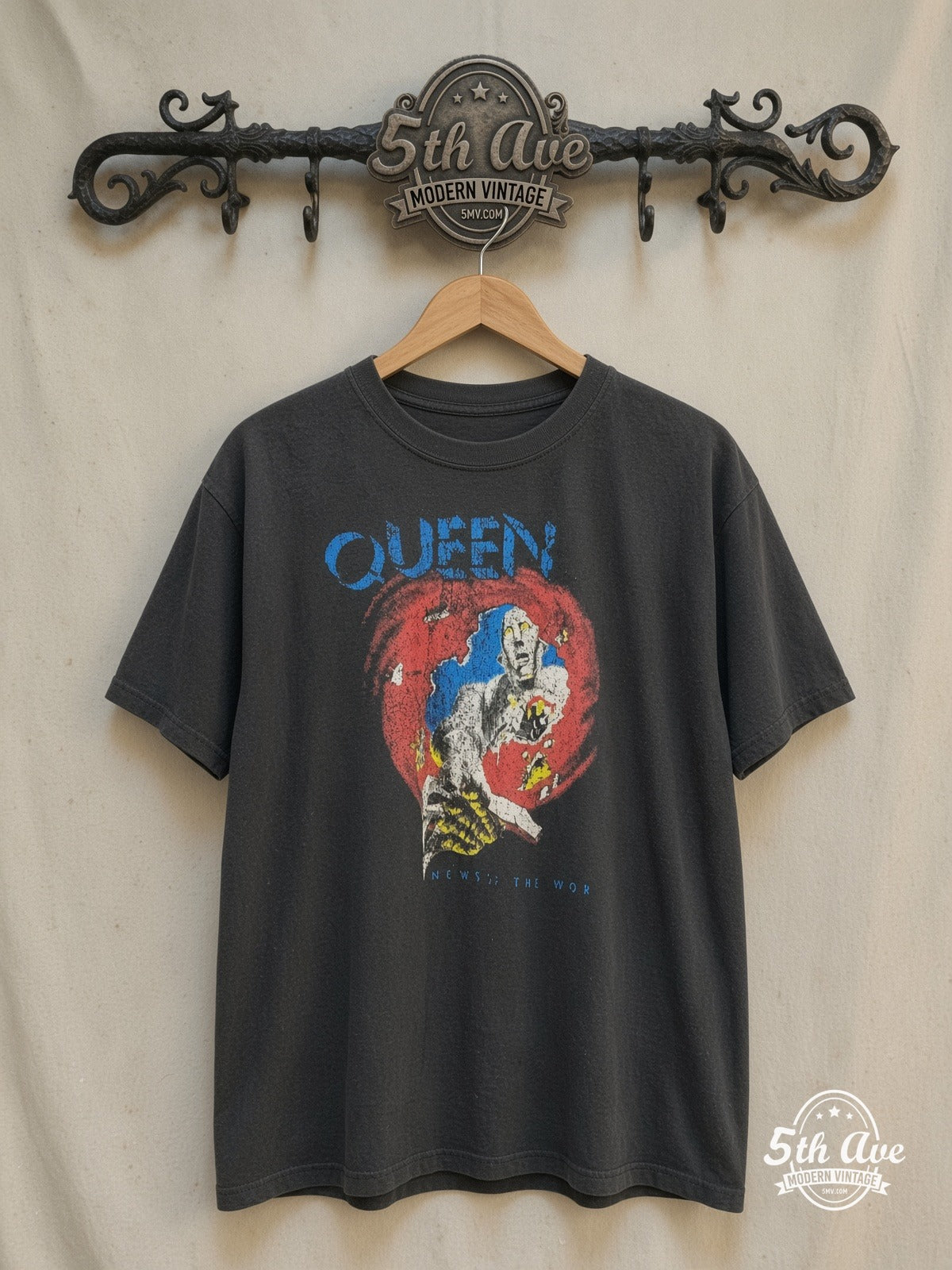 Queen – News of the World – Vintage Band T-Shirt — front on locked cream ornate 5th Ave rack