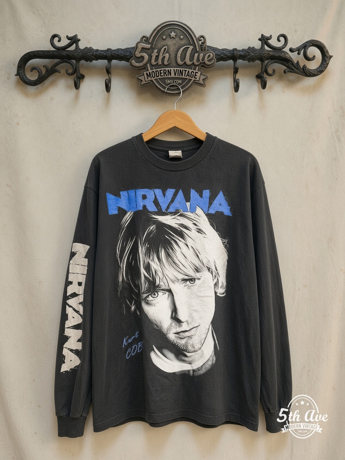 Nirvana – Kurt Cobain Blue Logo Play Electric Guitar Long Sleeve – Vintage Band T-Shirt — front on locked cream ornate 5th Ave rack