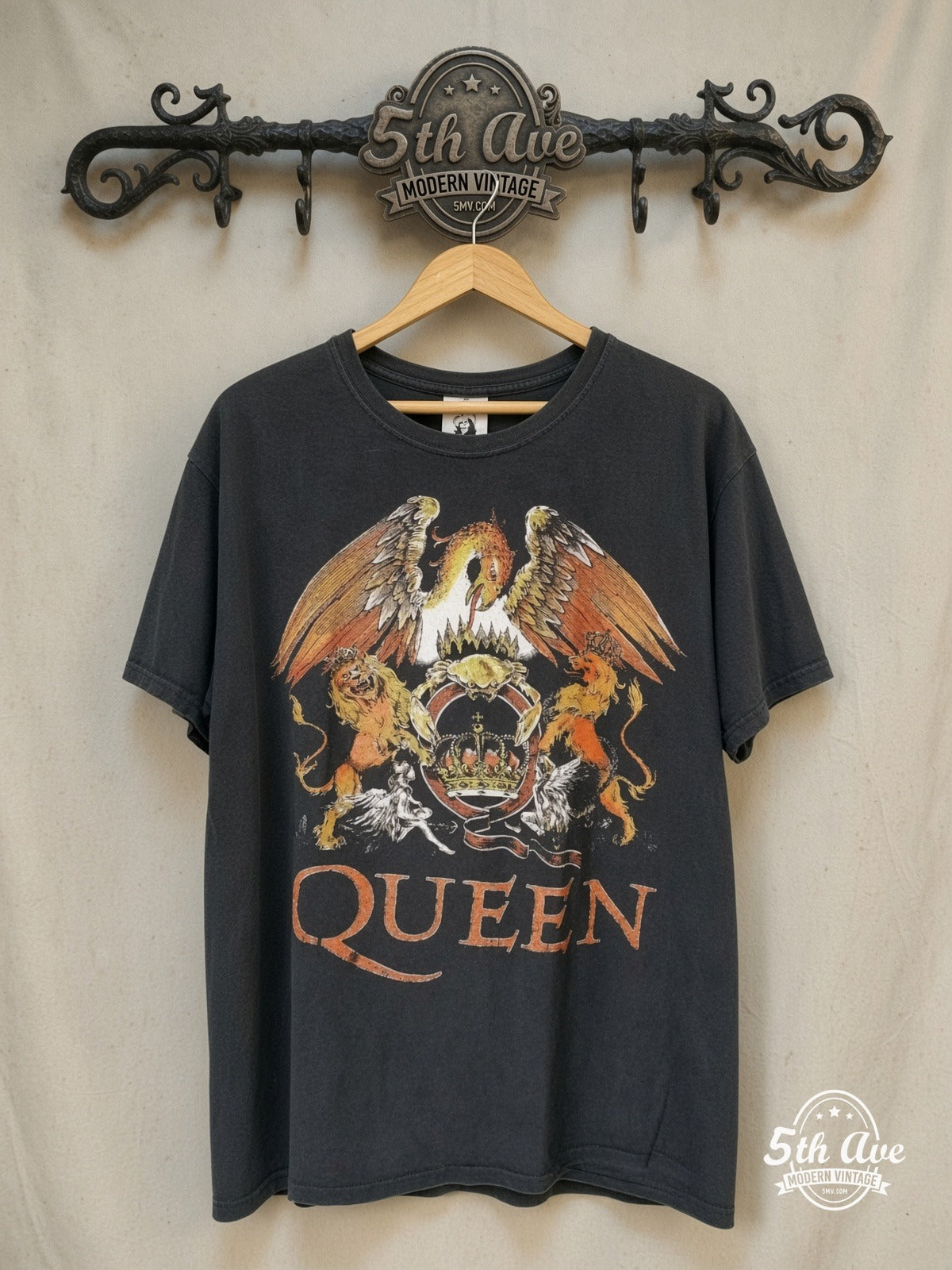 Queen – Color Crest Orange Logo – Vintage Band T-Shirt — front on locked cream ornate 5th Ave rack