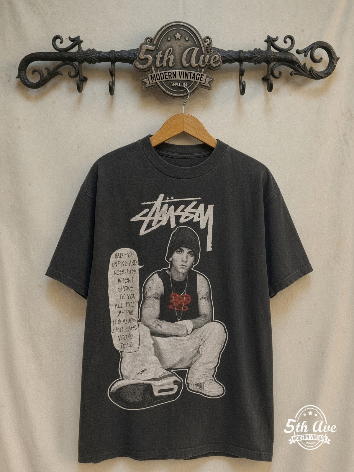 Eminem × Stüssy – Pins and Needles – Vintage Band T-Shirt — front on locked cream ornate 5th Ave rack