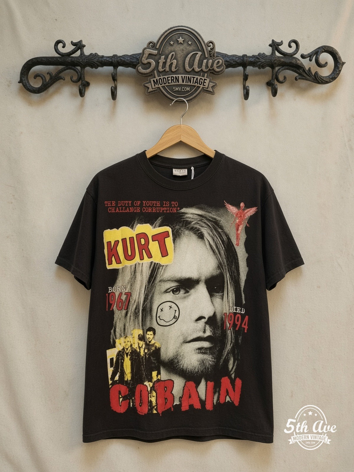 Kurt Cobain / Nirvana – Bootleg Graphic – Vintage Band T-Shirt — front on locked cream ornate 5th Ave rack