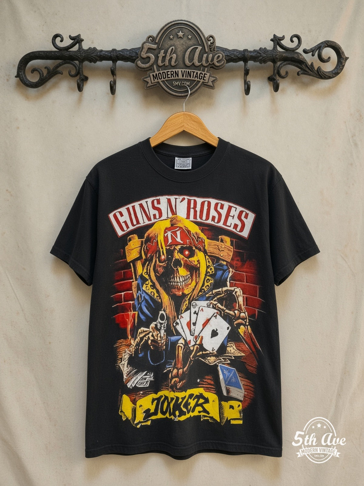 Guns N' Roses Joker Tattoo all-over-print vintage band t-shirt in black, front view on a display rack
