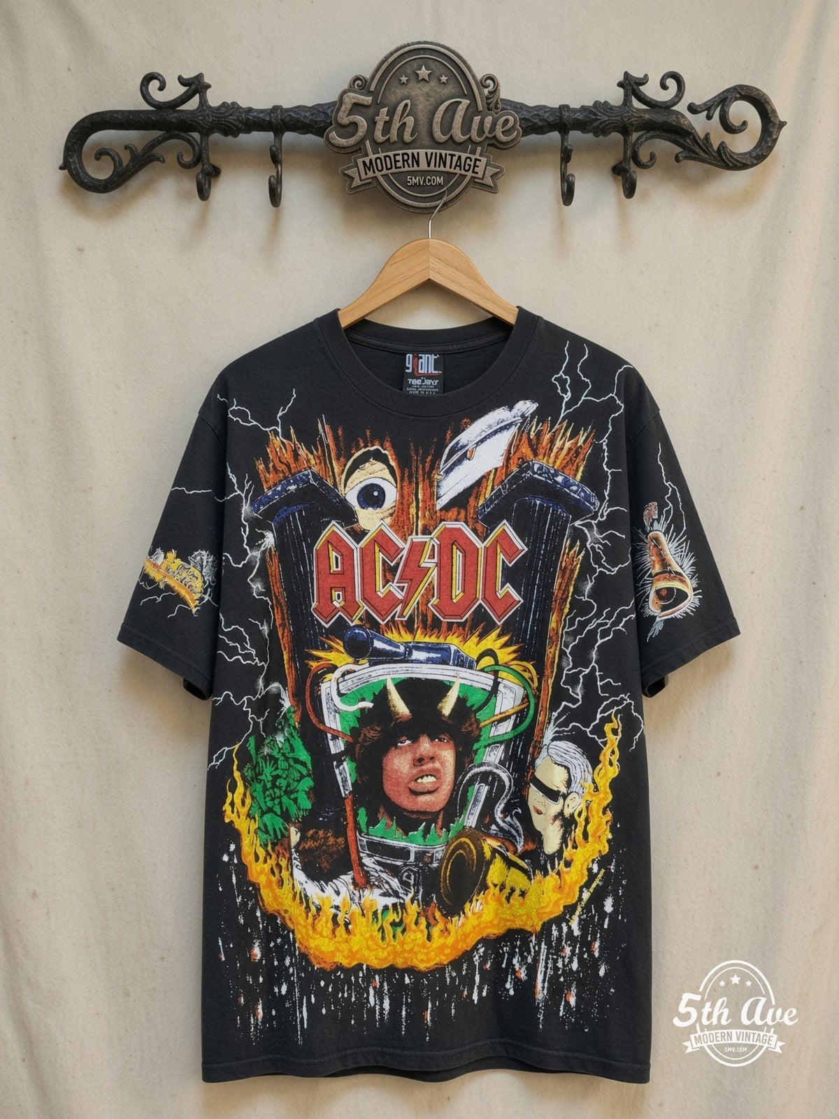 AC/DC – Thunderstruck Style: The Angus Young All-Over Print Single Stitch t sh – Vintage Band T-Shirt — front on locked cream ornate 5th Ave rack