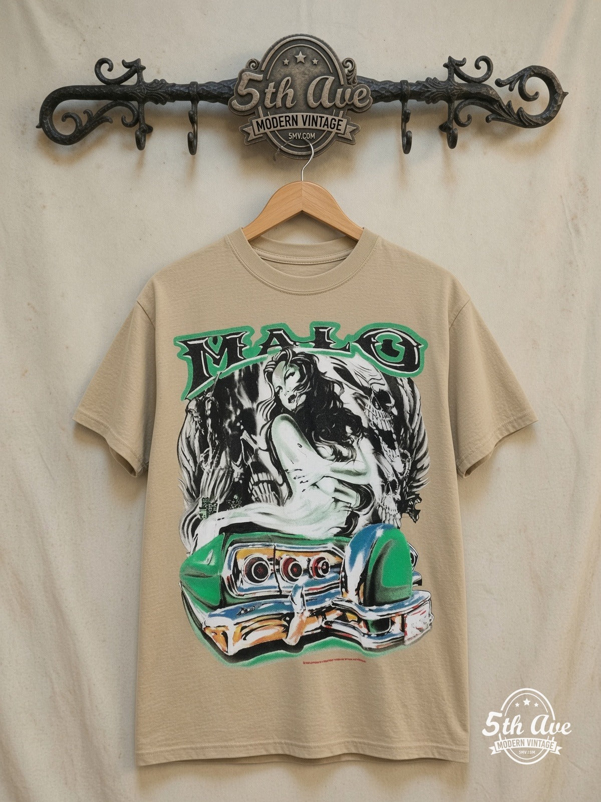 Malo pin-up and lowrider graphic tee, front view on a display rack