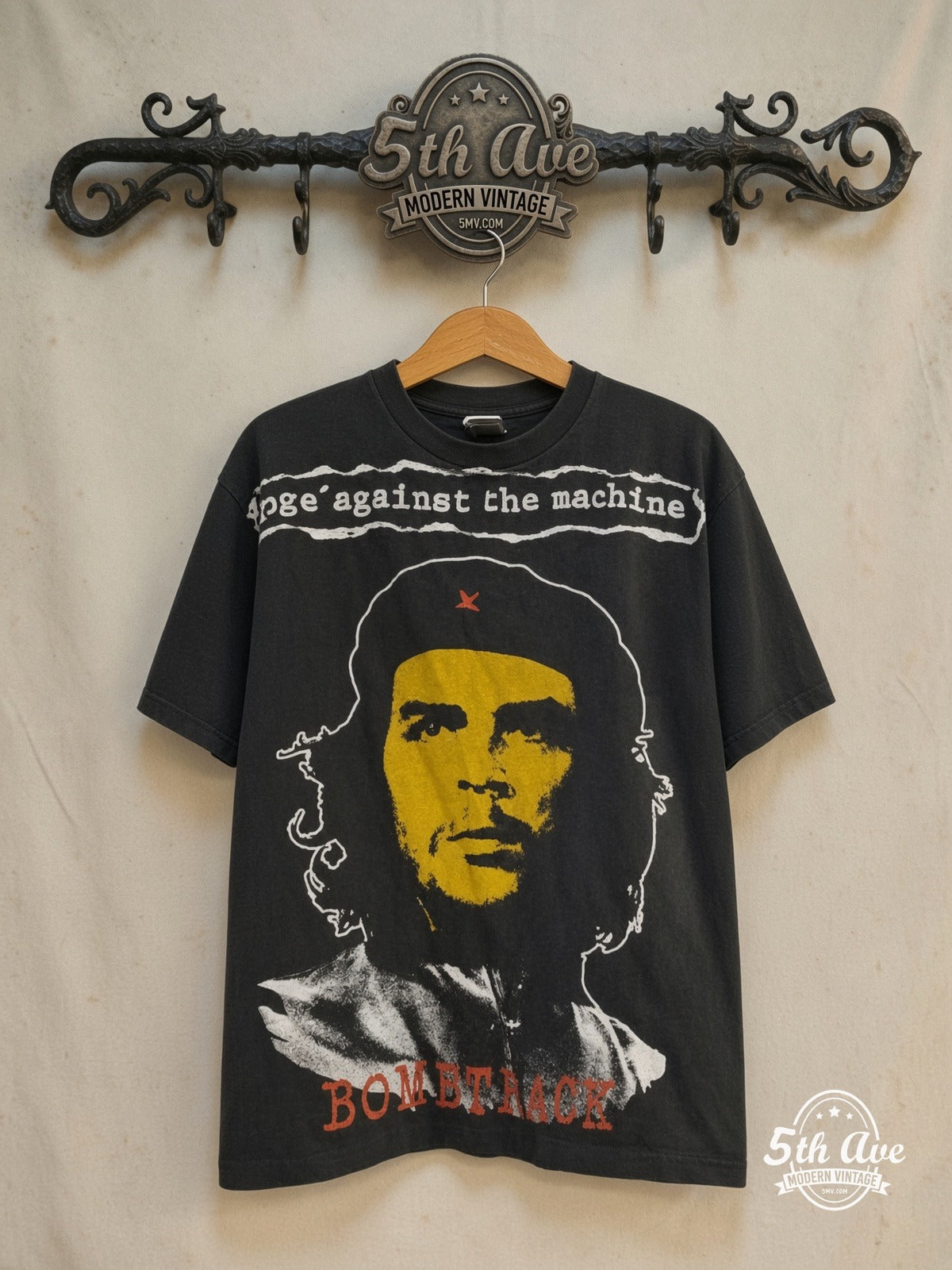 Rage Against the Machine – Bombtrack – All Over Print – Vintage Band T-Shirt — front on locked cream ornate 5th Ave rack