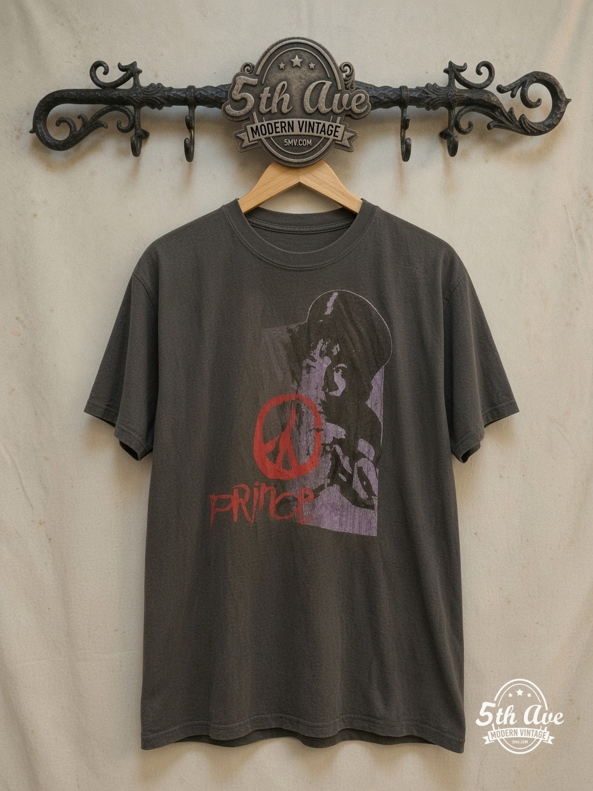 Prince – Purple Portrait Red Peace Sign – Vintage Band T-Shirt — front on locked cream ornate 5th Ave rack