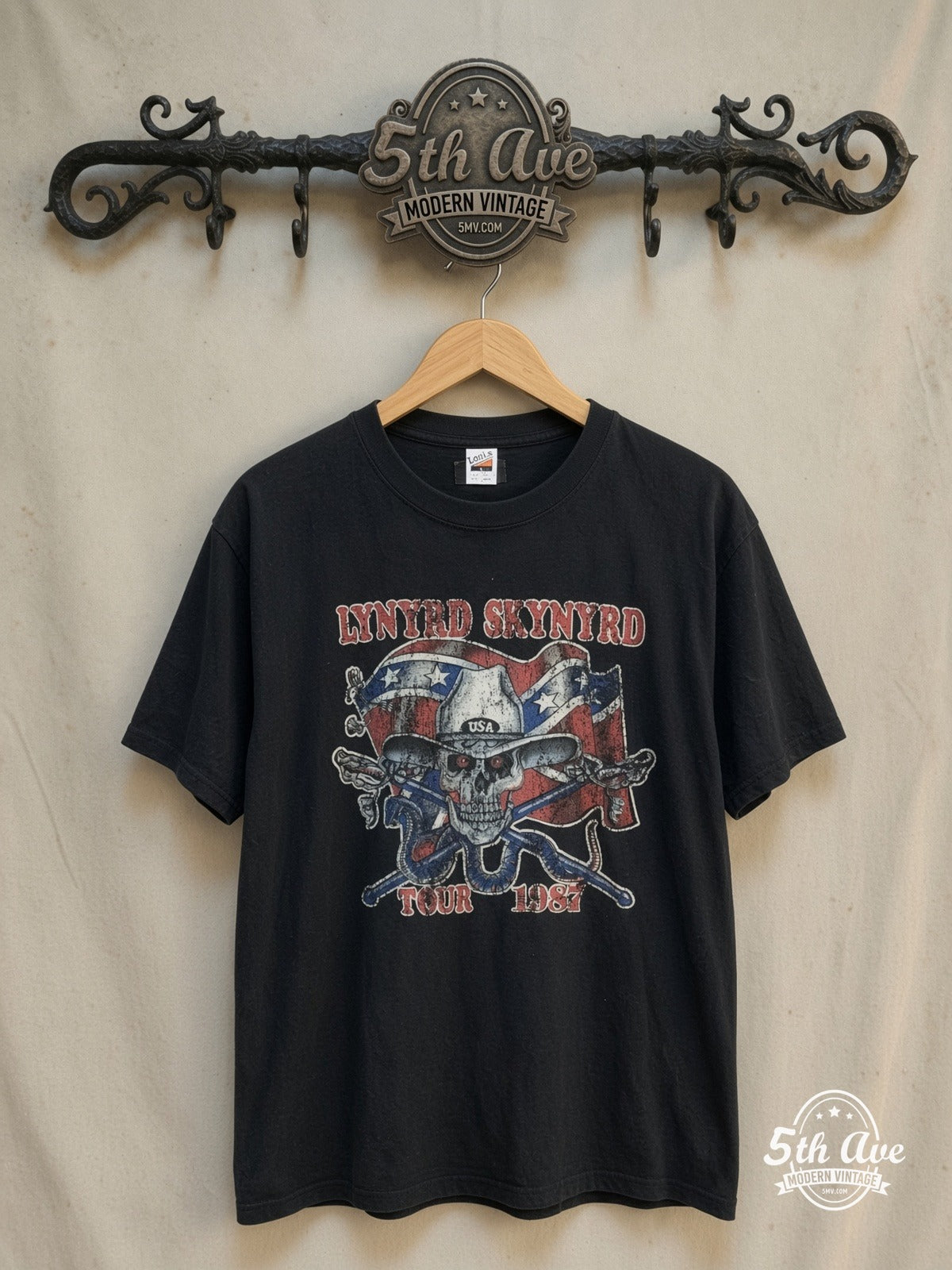 Lynyrd Skynyrd – 1987 Tour Rebel Skull – Vintage Band T-Shirt — front on locked cream ornate 5th Ave rack