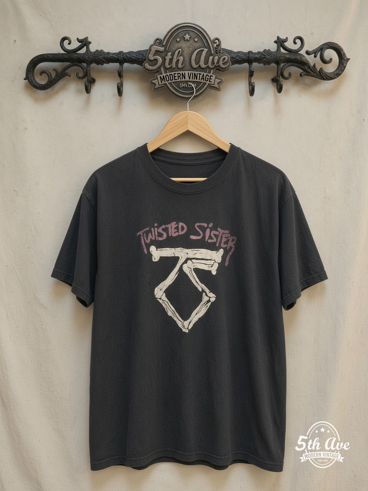 Twisted Sister – Bone TS Logo Pink Band Name – Vintage Band T-Shirt — front on locked cream ornate 5th Ave rack