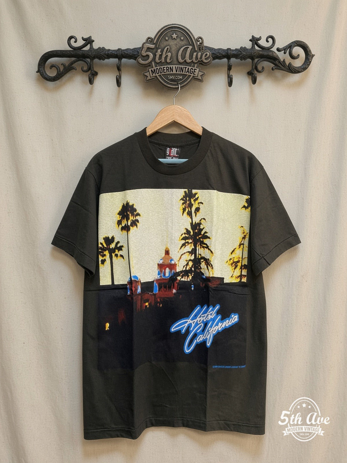 Eagles Hotel California Tribute Tee – Vintage Band T-Shirt — front on locked cream ornate 5th Ave rack