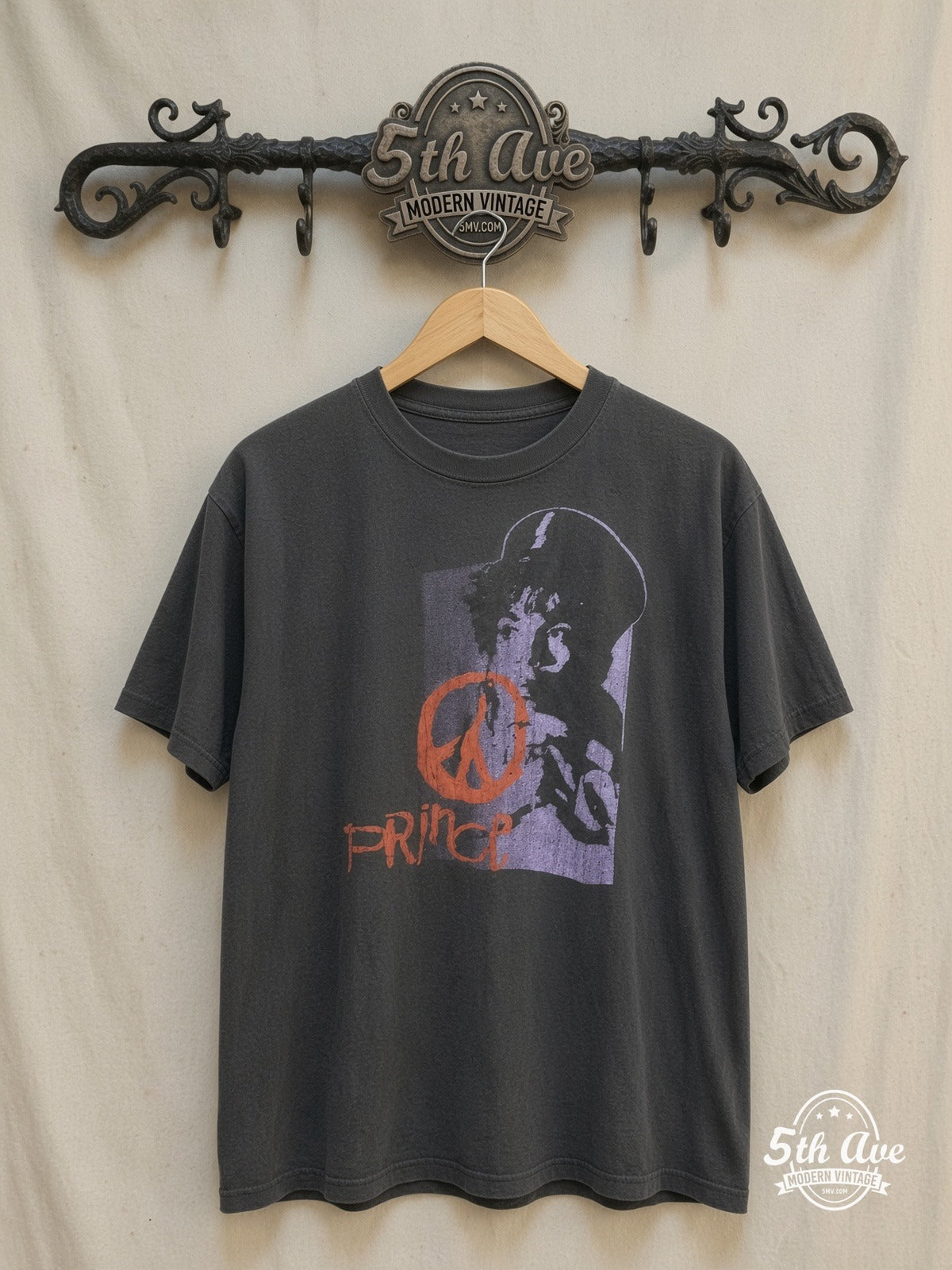 Prince – Purple Portrait Orange Peace Sign – Vintage Band T-Shirt — front on locked cream ornate 5th Ave rack